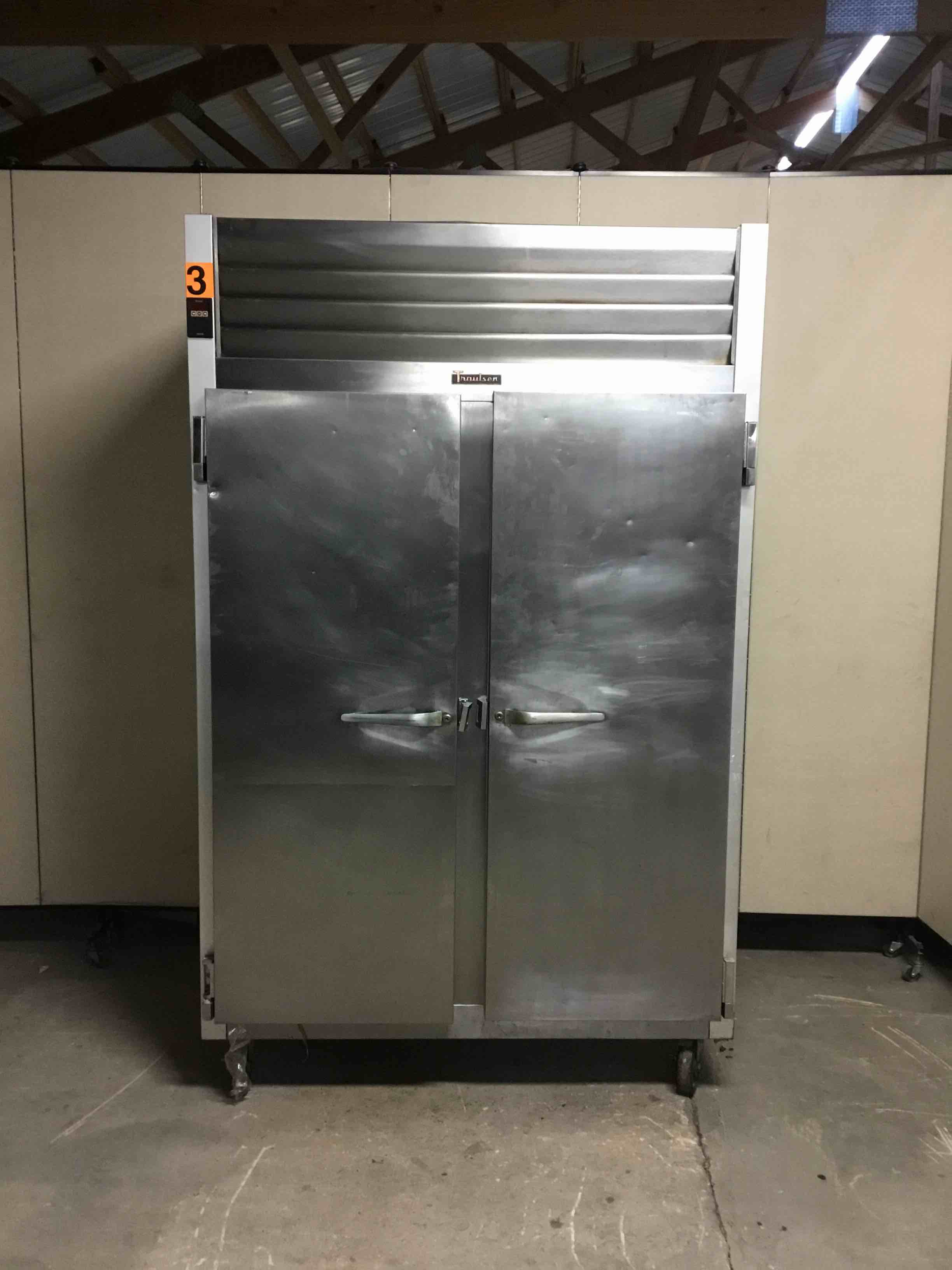 TRAULSEN TWO DOOR STAINLESS STEEL REACH IN FREEZER ON CASTERS