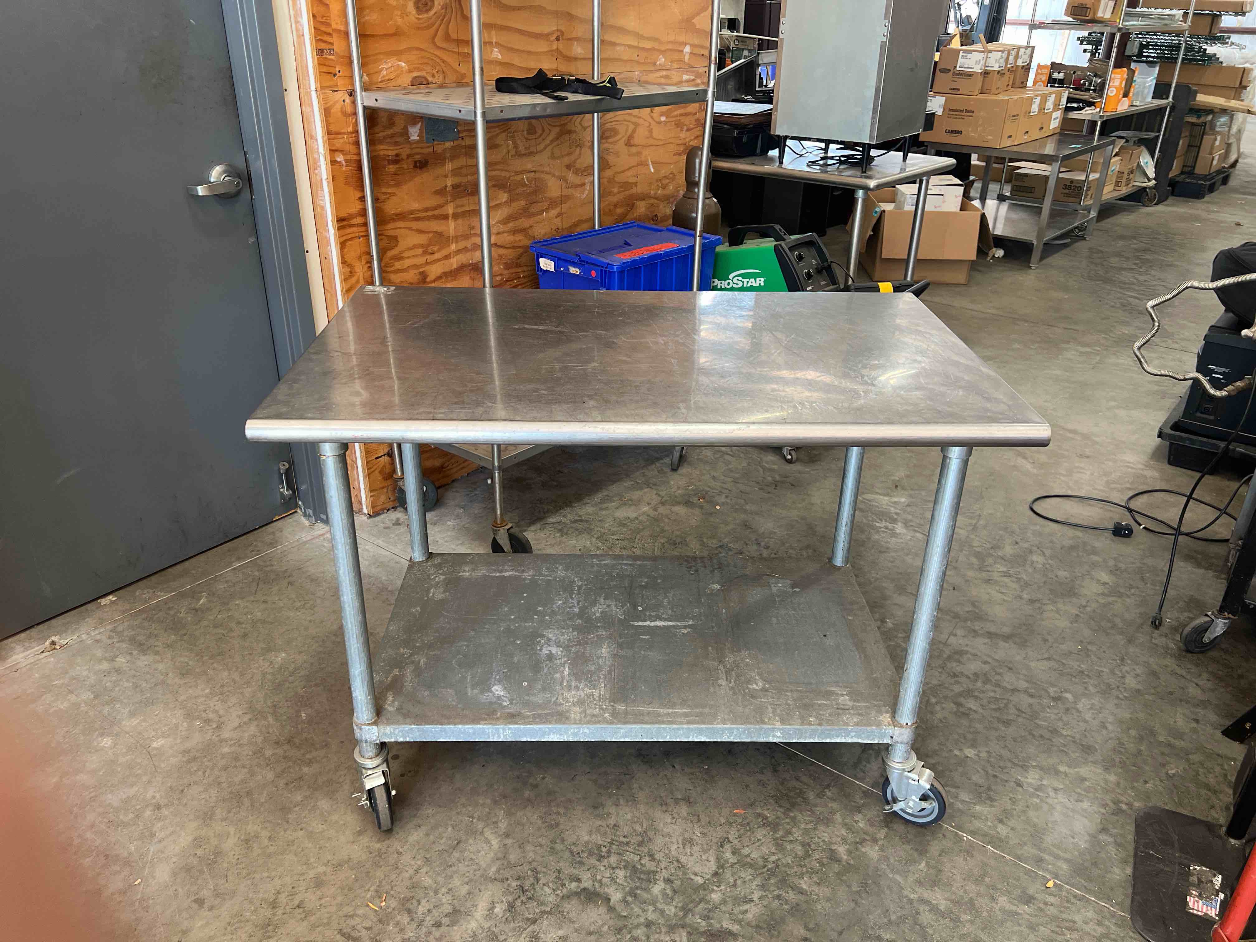 48 INCH STAINLESS STEEL TABLE WITH UNDER SHELF ON CASTERS 