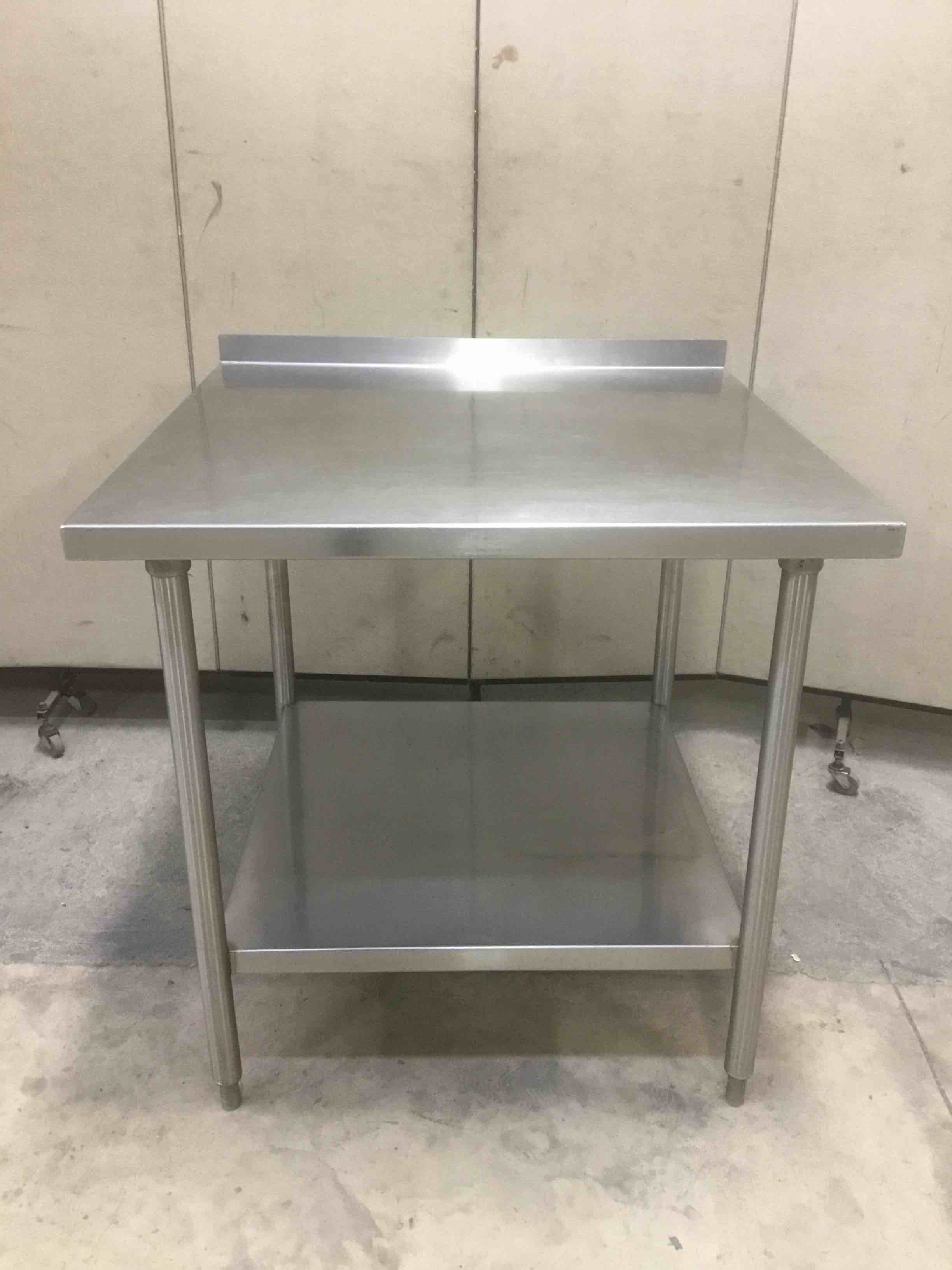 36 INCH STAINLESS STEEL TABLE WITH UNDERSHELF AND 2 INCH BACKSPLASH 