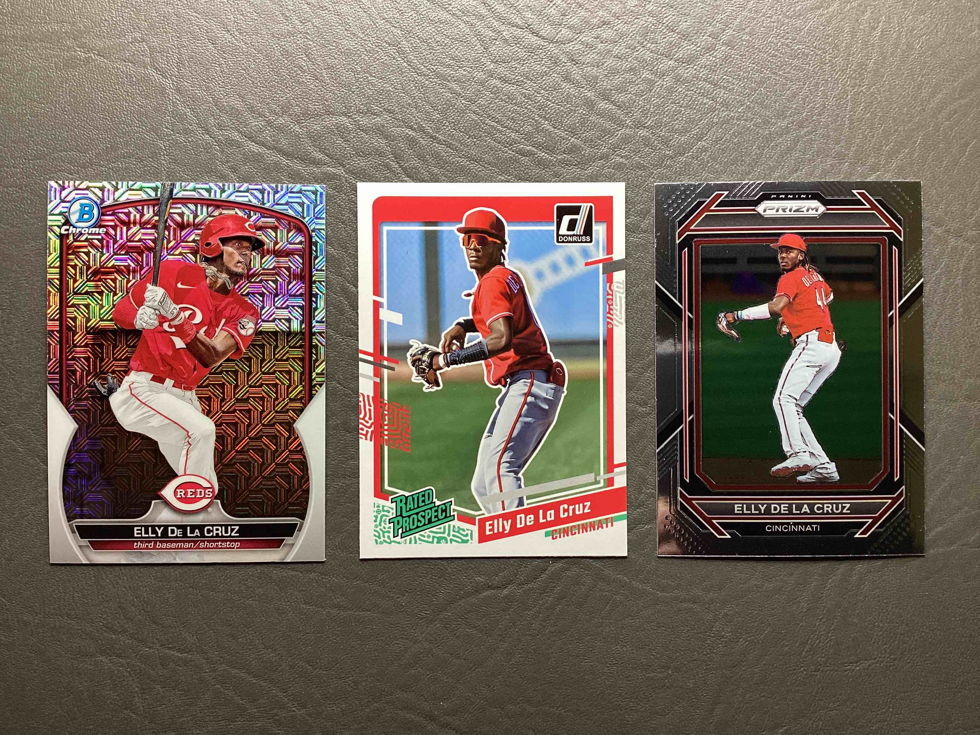 Reds Fans!  Elly De La Cruz Rookie Card Lot!  Three Great Cards, Bowman Chrome Refractor, Donruss Rated Prospect & Panini Prizm.  All Mint!