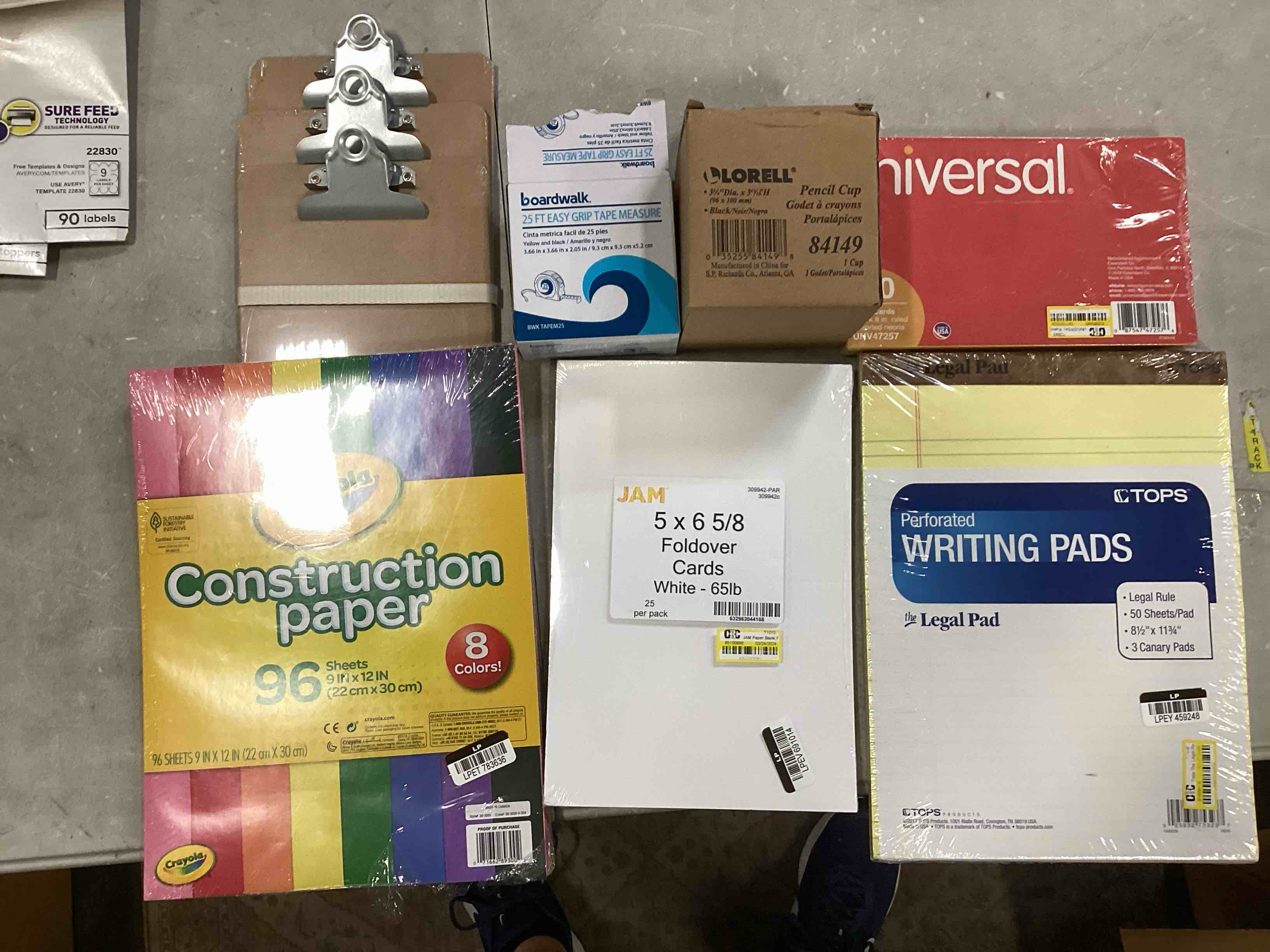 assorted papers, pencil cup, tape measure, and mini-clipboards