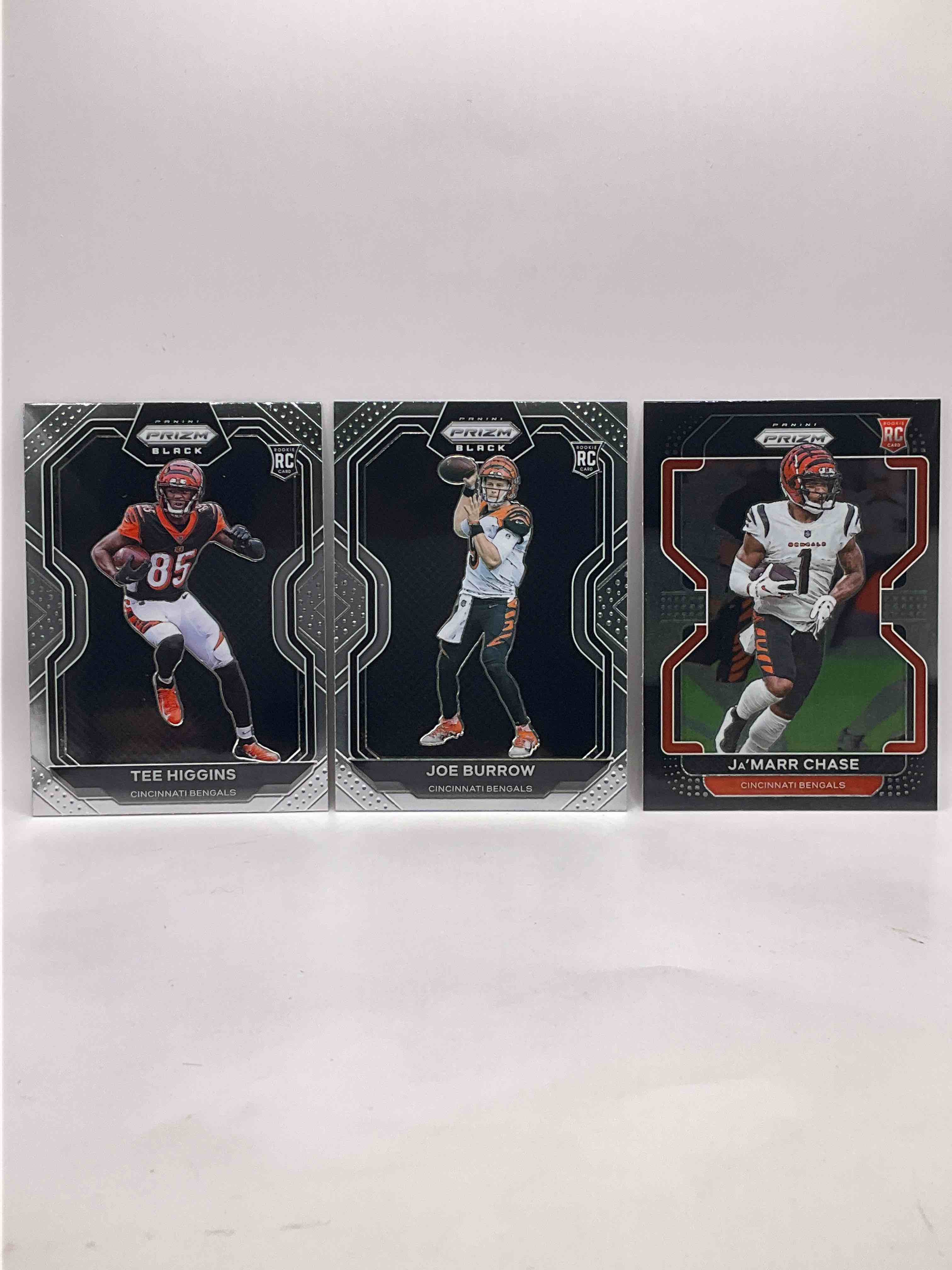 PRIZM BLACK Edition Rookies! Bengals Big Three! Tee Higgins Prizm Black Rookie, Joe Burrow Prizm Black Rookie & Ja’marr Chase Prizm Black Rookie! All Mint!