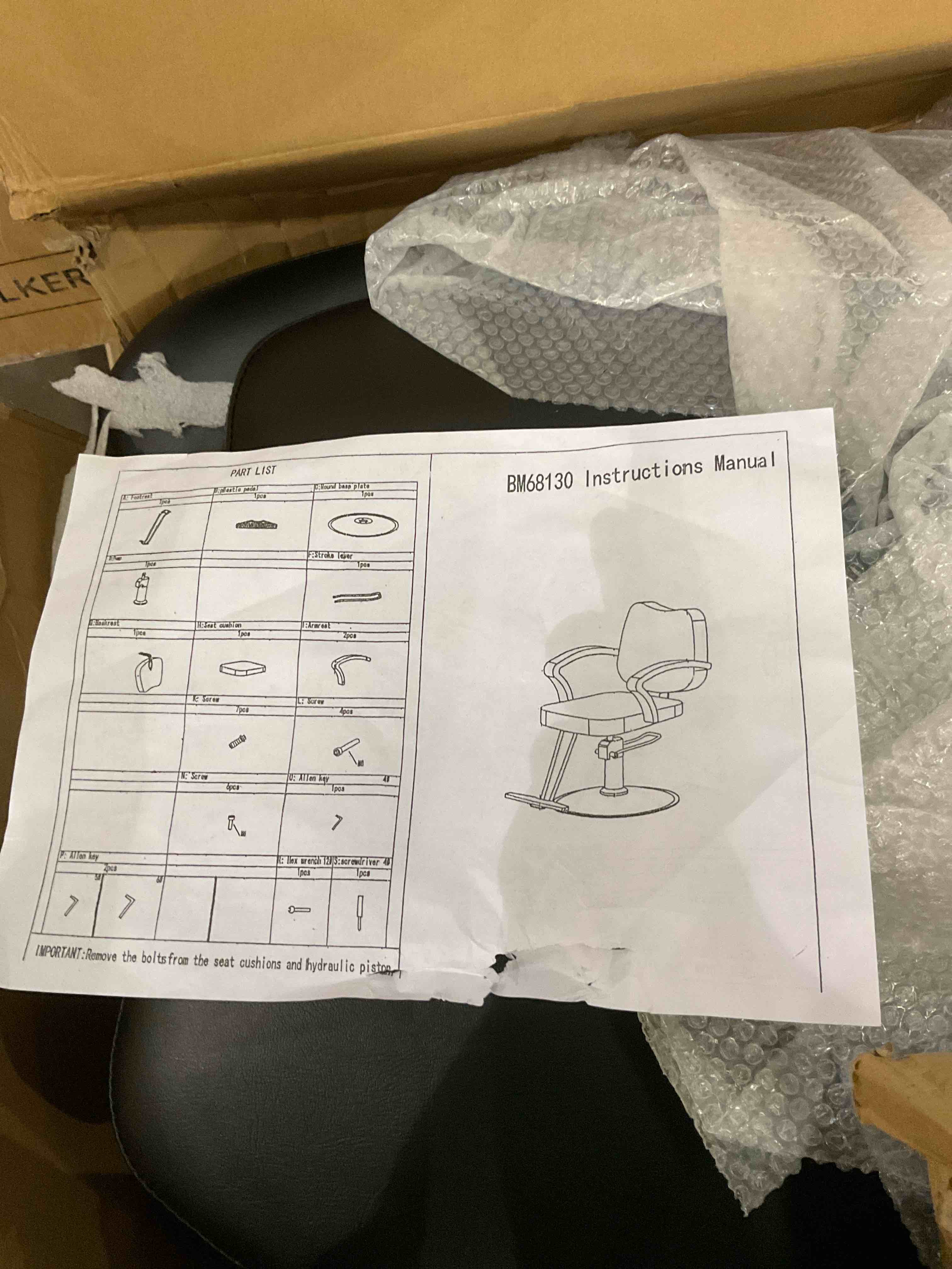 black armchair with leg support parts shown only