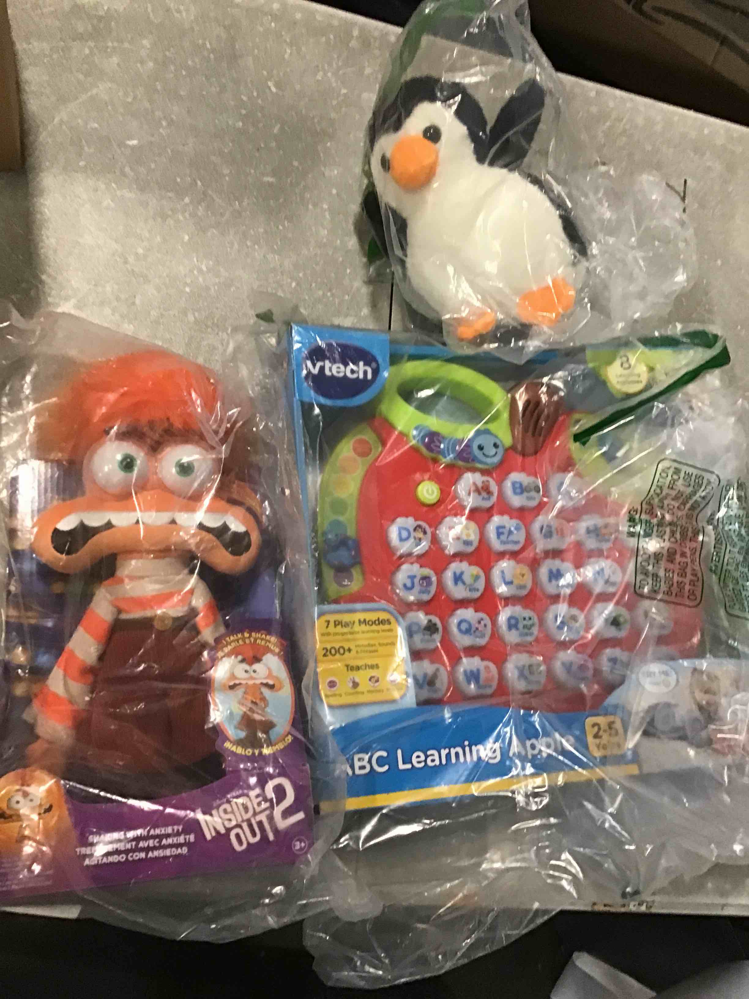 Assorted children’s toys of different ages, including ABC Learnig Apple INSIDE OUT 2. small plush pinging