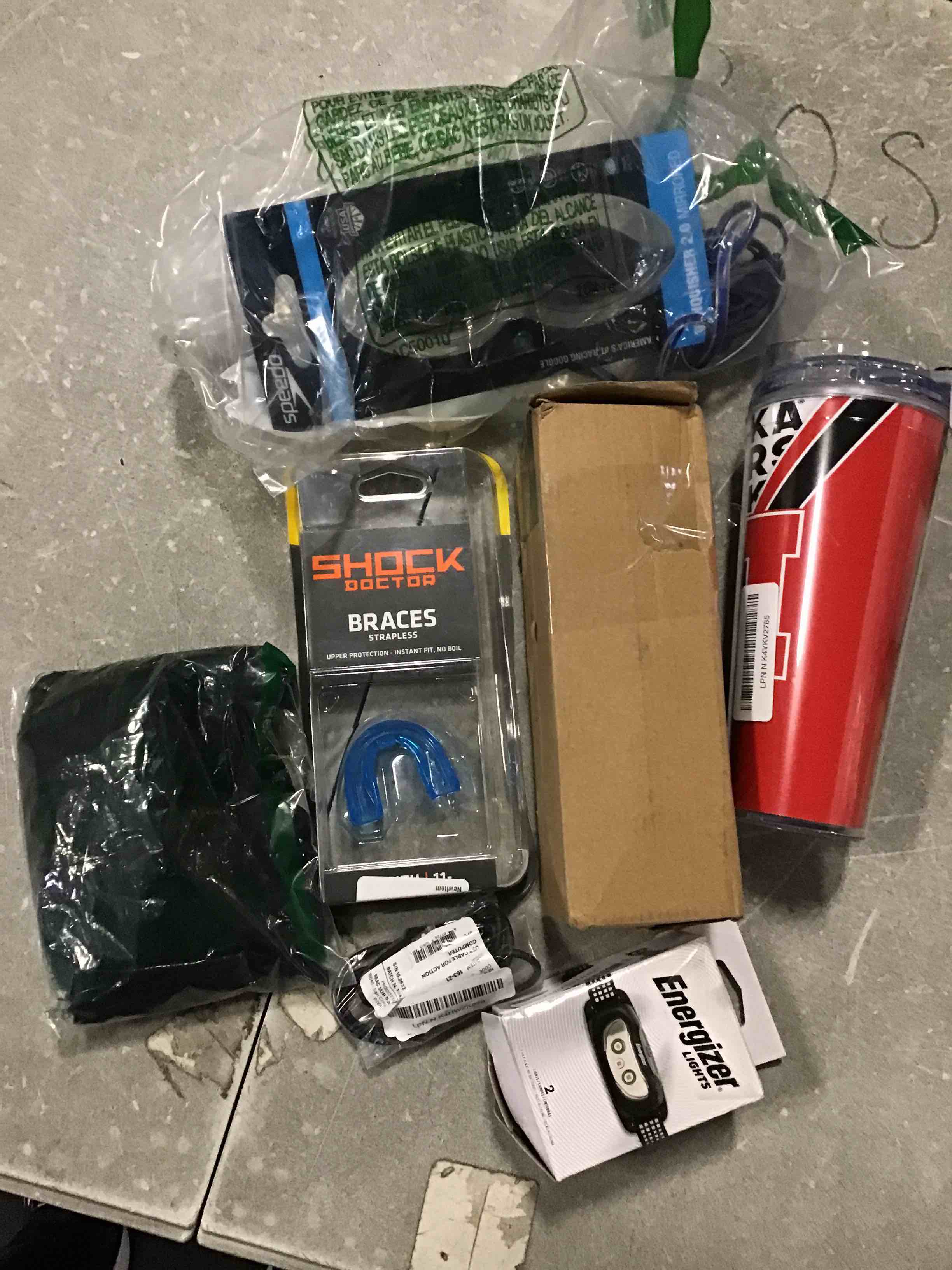 Assorted of different products inclulle, Golf Balls. 1 thermal glass Shock Doctor Braces Strapless Energezer Lights