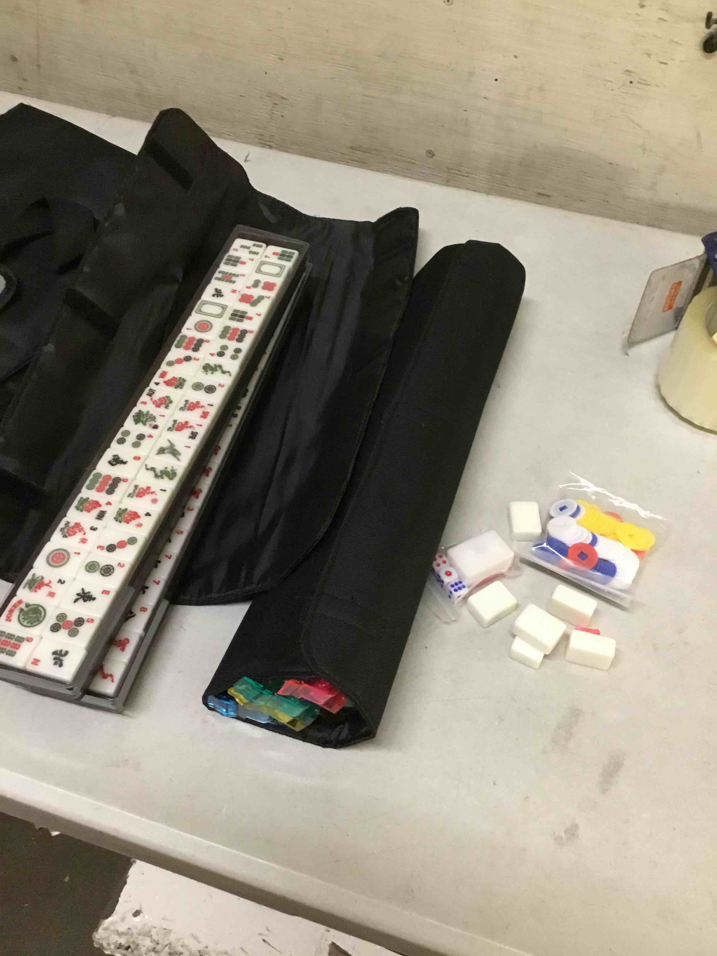 Condition photo showing As Is for ( incomplete missing pink rack ) mahjong tile set,166 white tiles mahjong set, 4 all-in-one rack/pushers /3 dice, /100 money chips /1 mahjong instructions, american mahjong set with black carrying bag