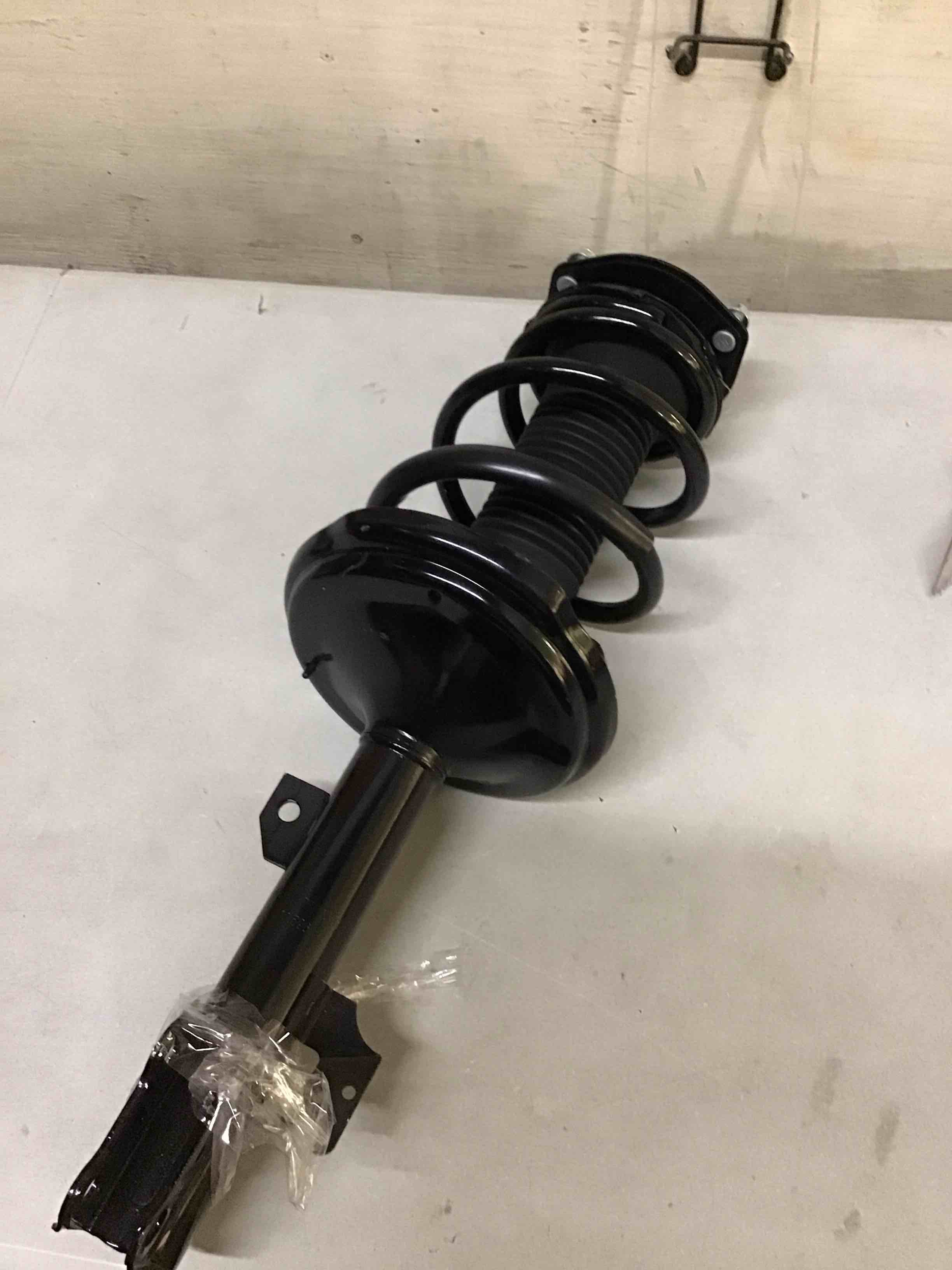 Condition photo showing As Is for strut spring