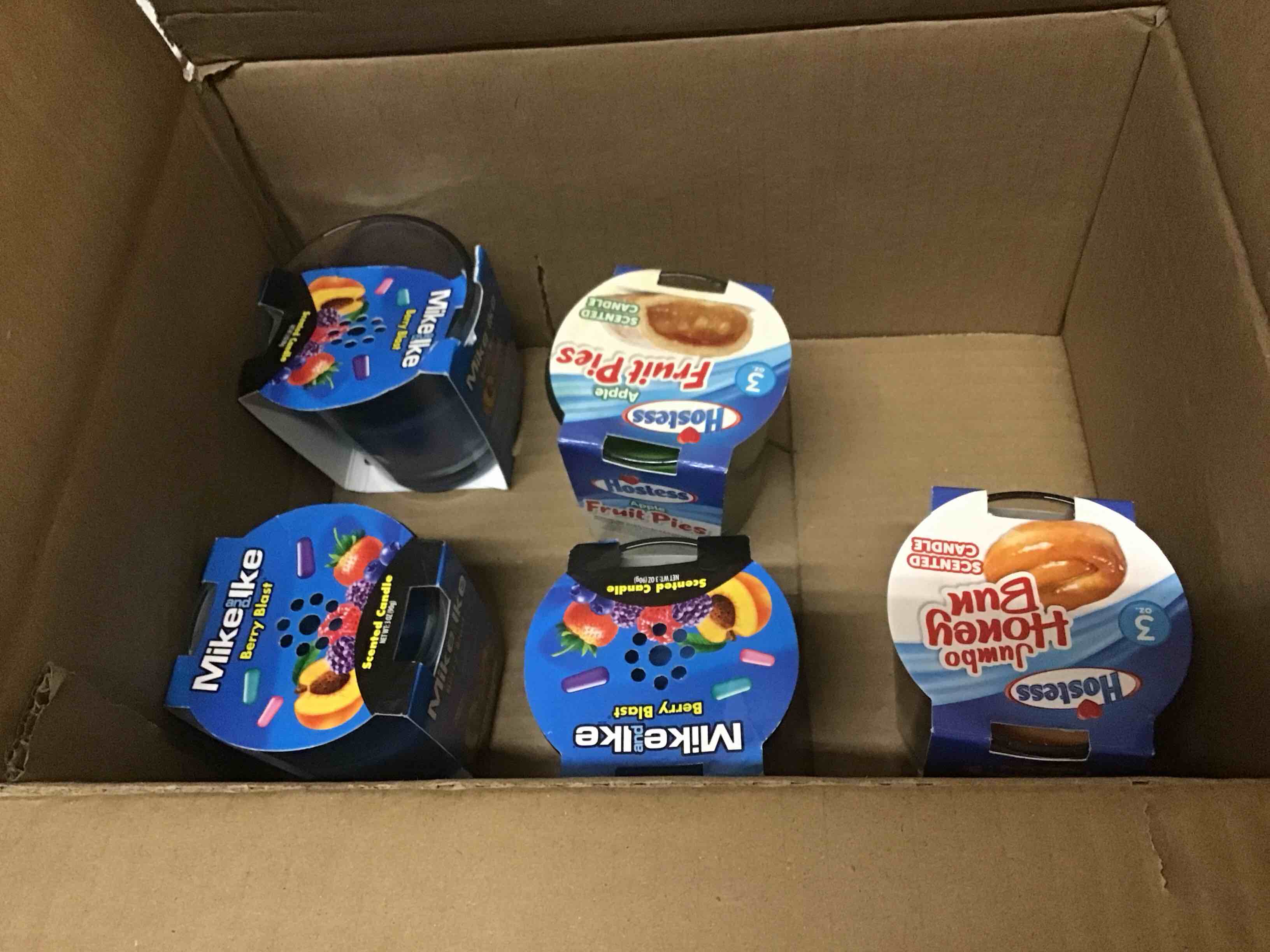 Condition photo showing As Is for (incomplete) pack of 6 hostess scented candle - scents vary