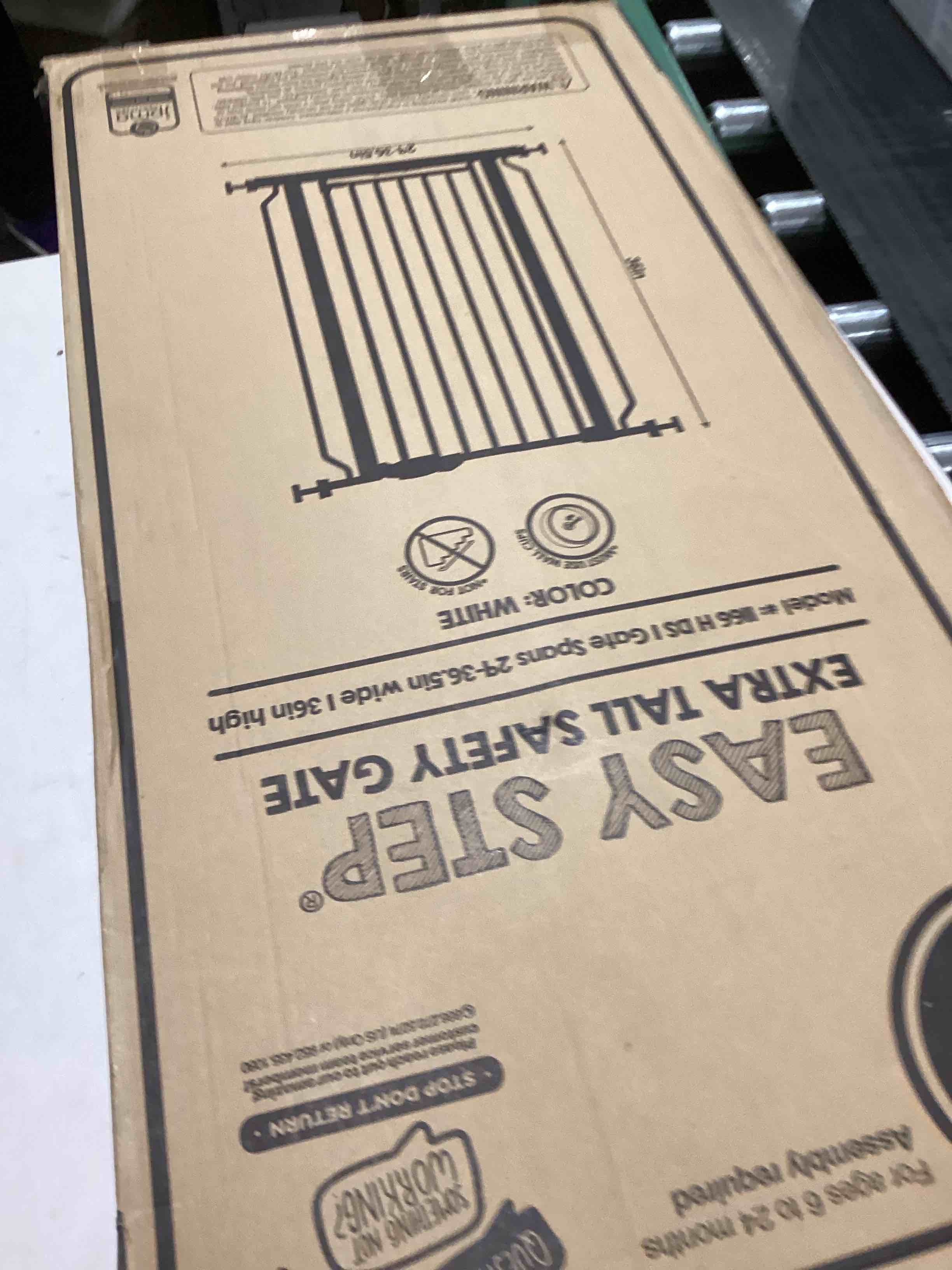 Condition photo showing As Is for Regalo Easy Step Extra Tall Walk Thru Baby Gate, Includes 4-Inch Extension, and 4 Pack of Wall Cups and Mounting Kit, White White 29-36.5"W x 36"H