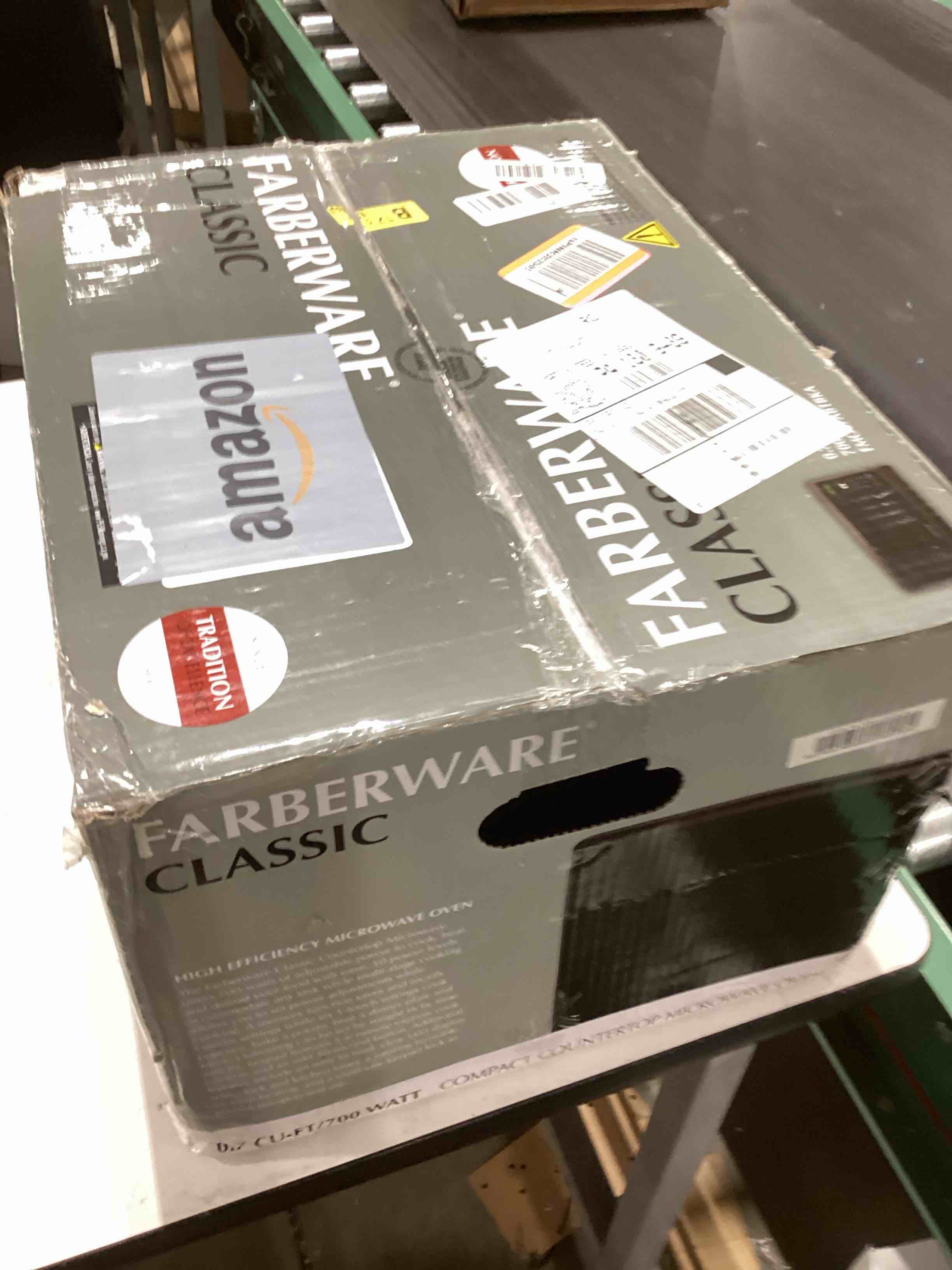 Condition photo showing As Is for Farberware 0.7 Cu. Ft. Countertop Microwave Oven – 700 Watts Power, Auto Cook Settings, Defrost, Easy Clean and Child Safety Lock - Black 0.7 Cu. Ft Black