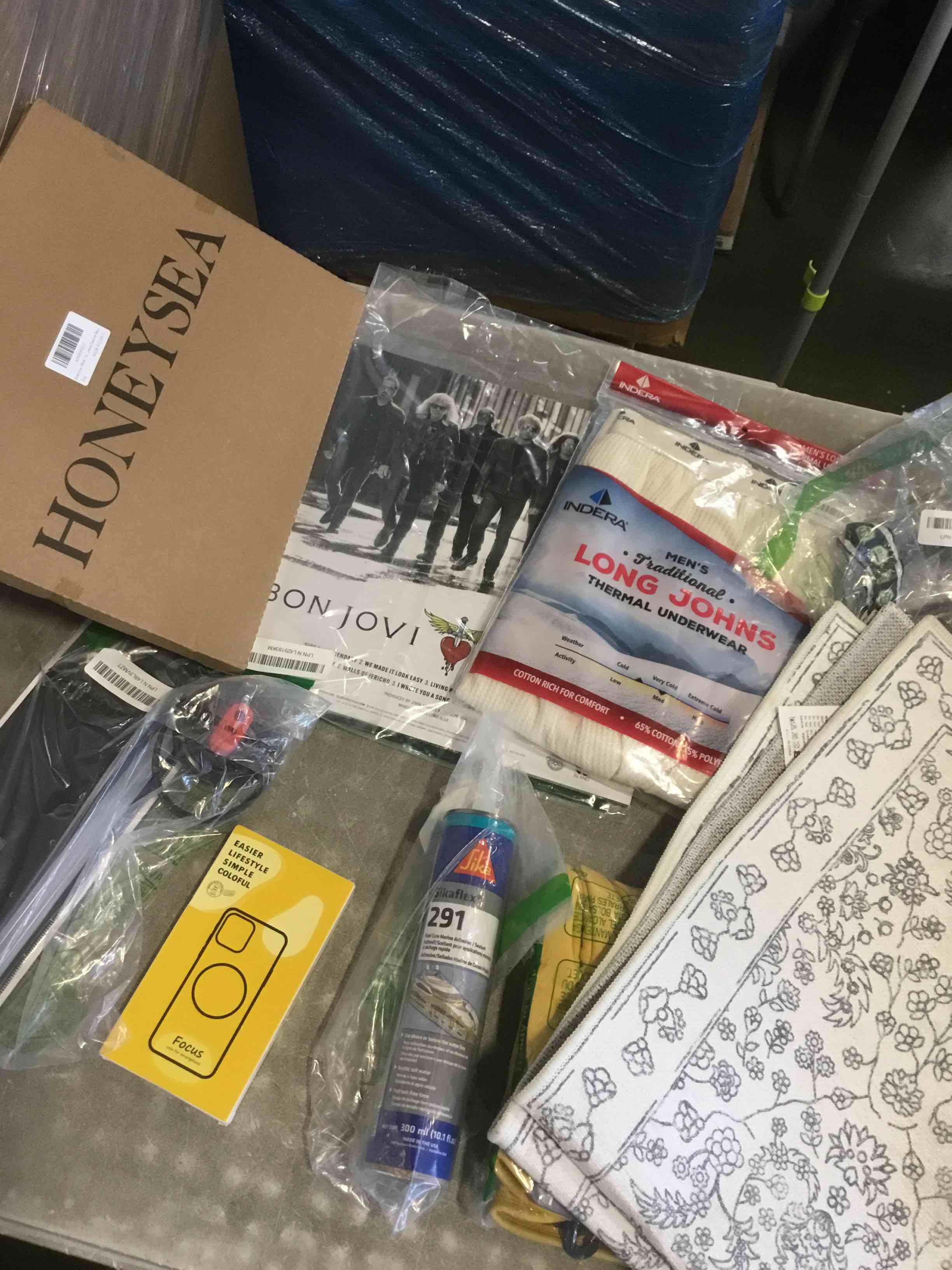 assorted of different products included ( mat indoor area rug , sikaflex , men’s long johns thermal underwear,  and more )