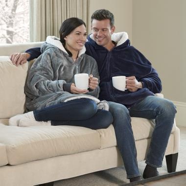 This is the oversized garment that provides head-to-toe warmth for reading on the couch, watching a documentary on television, or studying in the dorm. Combining the benefits of a blanket and a sweatshirt, it features an oversized hood and roomy pockets for warming the hands or storing a smartphone or remote. With 100% polyester fleece face and 100% polyester fleece lining. One size fits all. Reversible with full front zipper. Machine wash. Imported. Black, Blue, or Grey. 35" L x 29" W x 2" D.