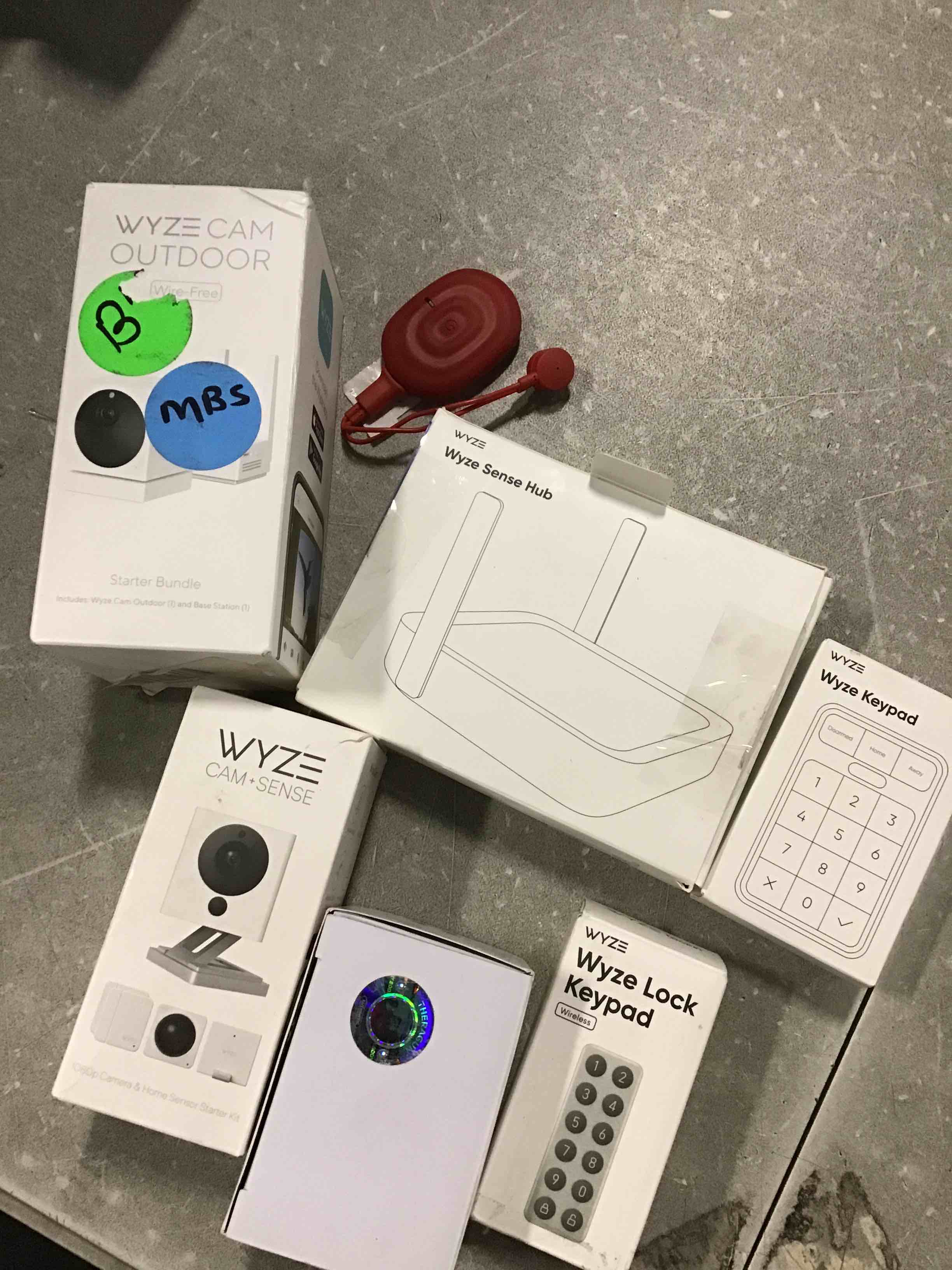 AssortedOf Miscellaneoous Products of WYZE Include WYZE Cam Outdoor Wire Free, Wize Cam + Sense, WYZE Lock Keypad,WYZE Sense Hub, WYZE Keypad
