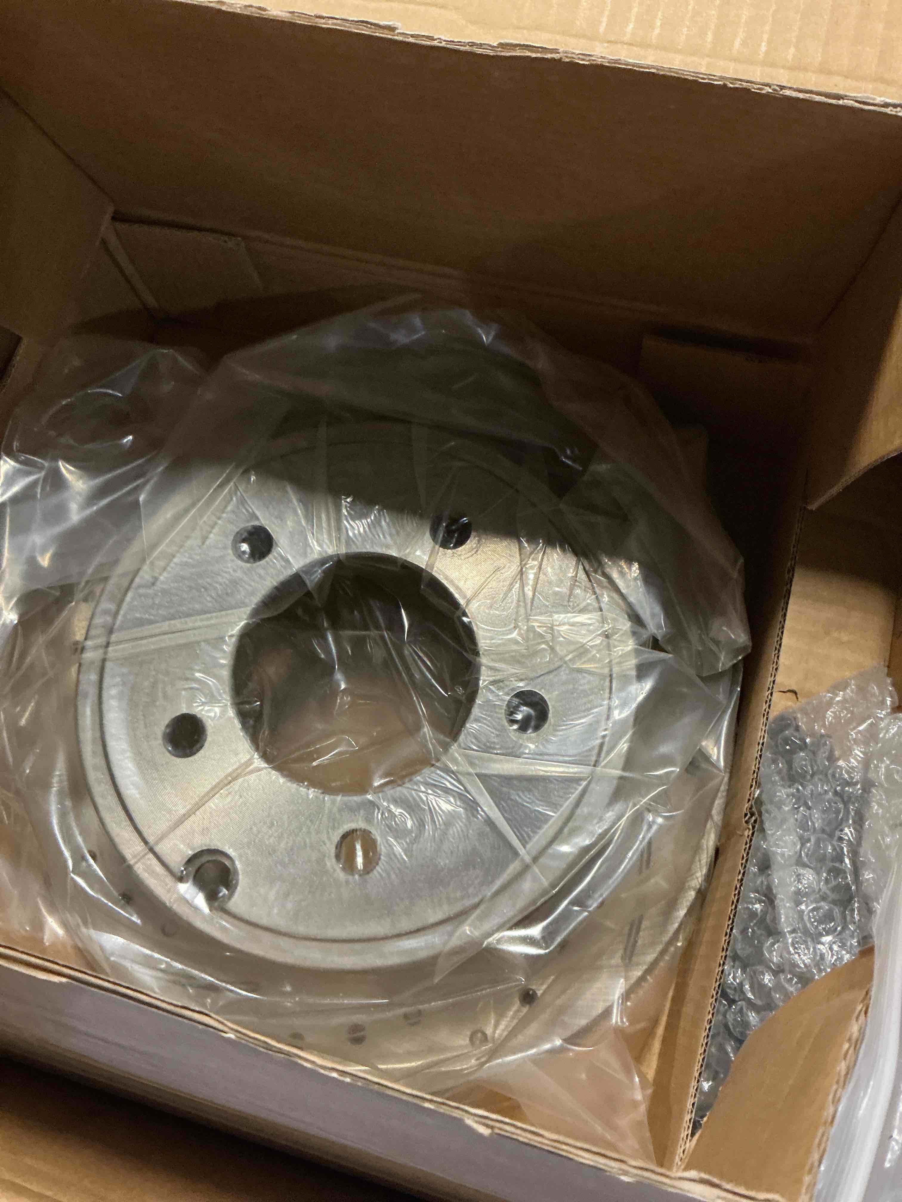 Condition photo showing item condition for 2pcs Disc Brake Rotor Set Front Rear Left Driver and Right Passenger Side Silver Zinc Plated Steel Performance Drilled and Slotted V8 for F250 SuperDuty 05-12 for F350 SuperDuty 05-12