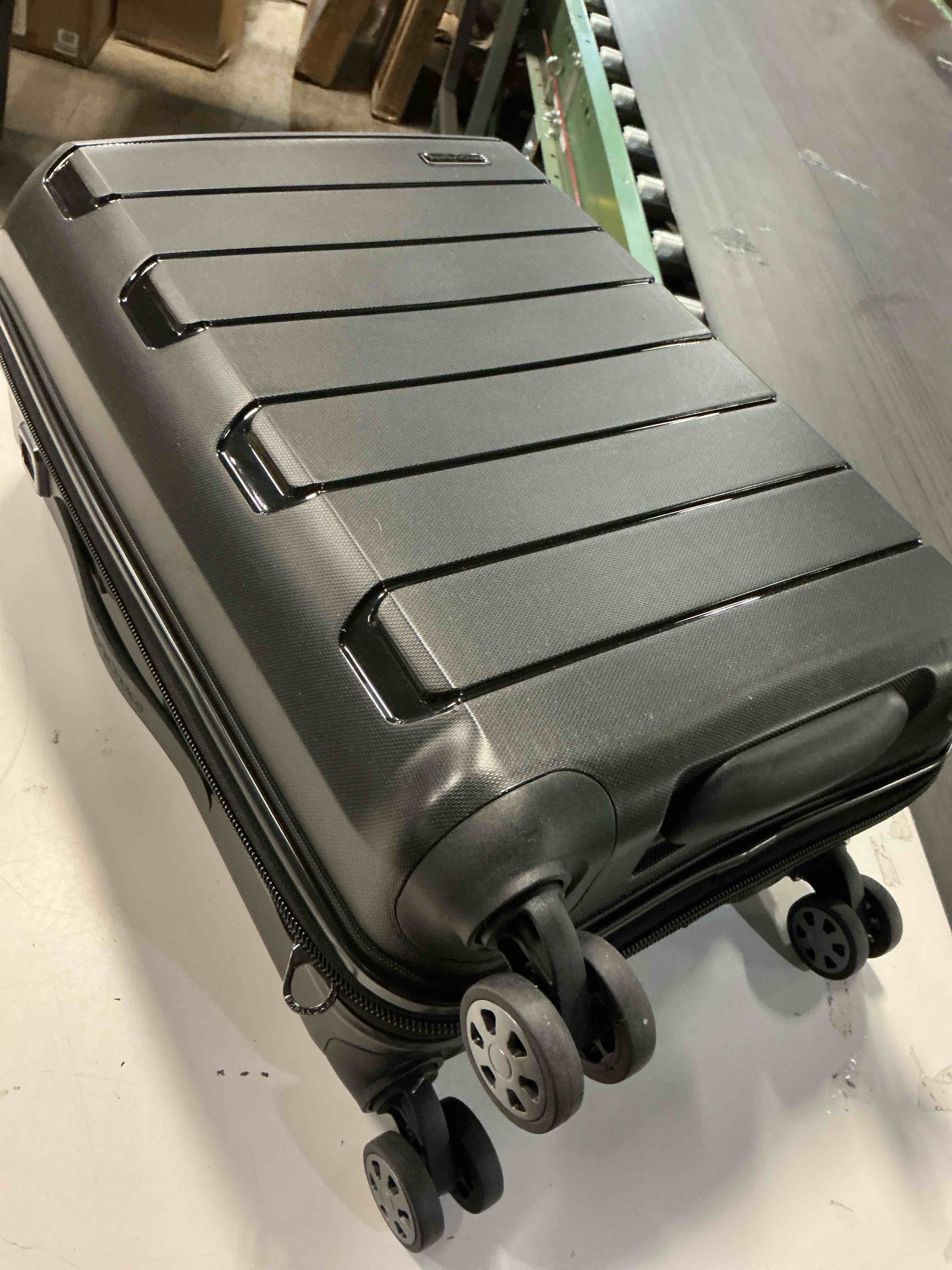 Condition photo showing As Is for Traveler's Choice Pagosa Indestructible Hardshell Expandable Spinner Luggage, Black, 22-Inch Carry-on 22-Inch Carry-on Black