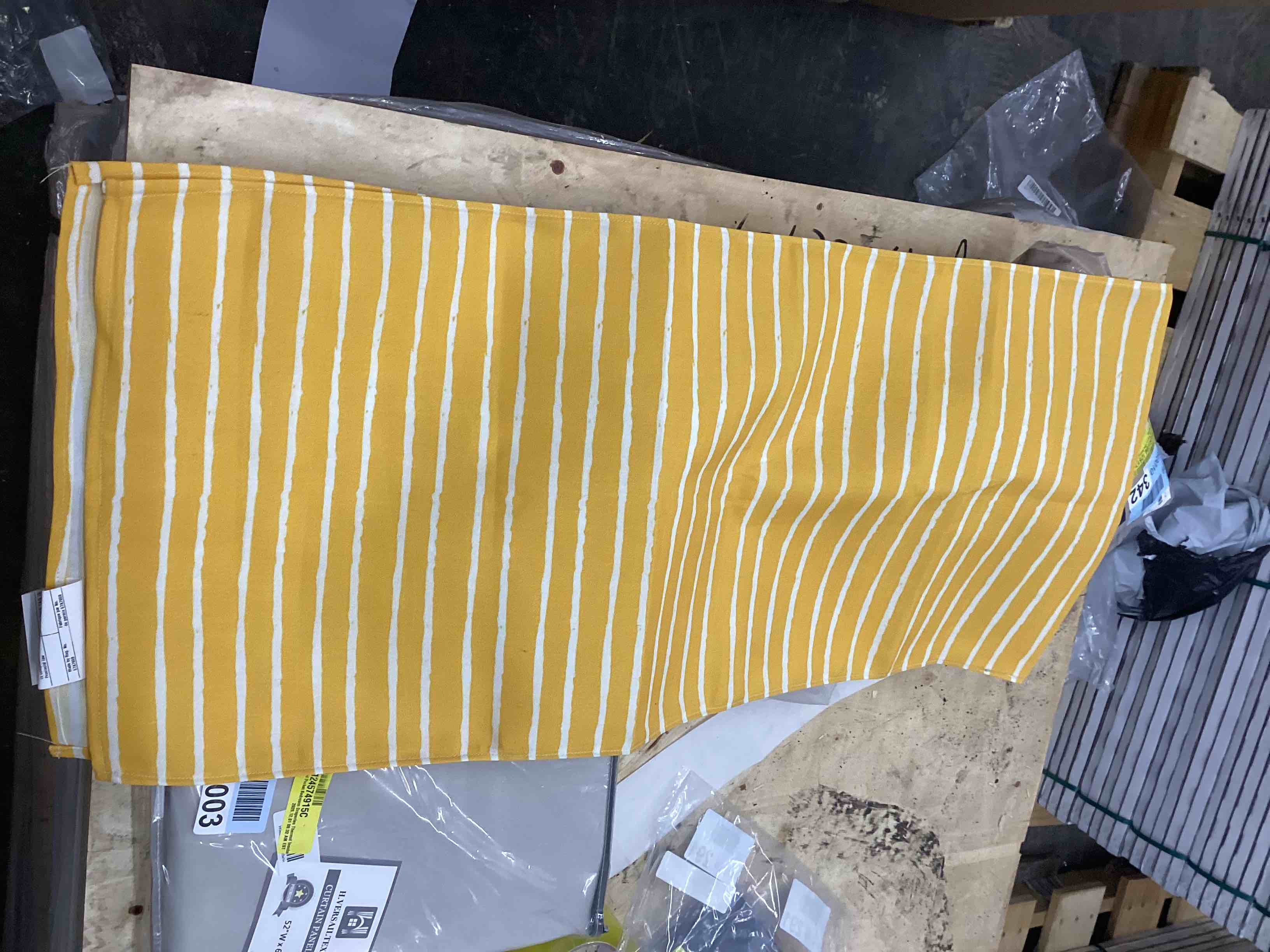 Assortment of tablecloths, pillowcases, bed camera and curtains.