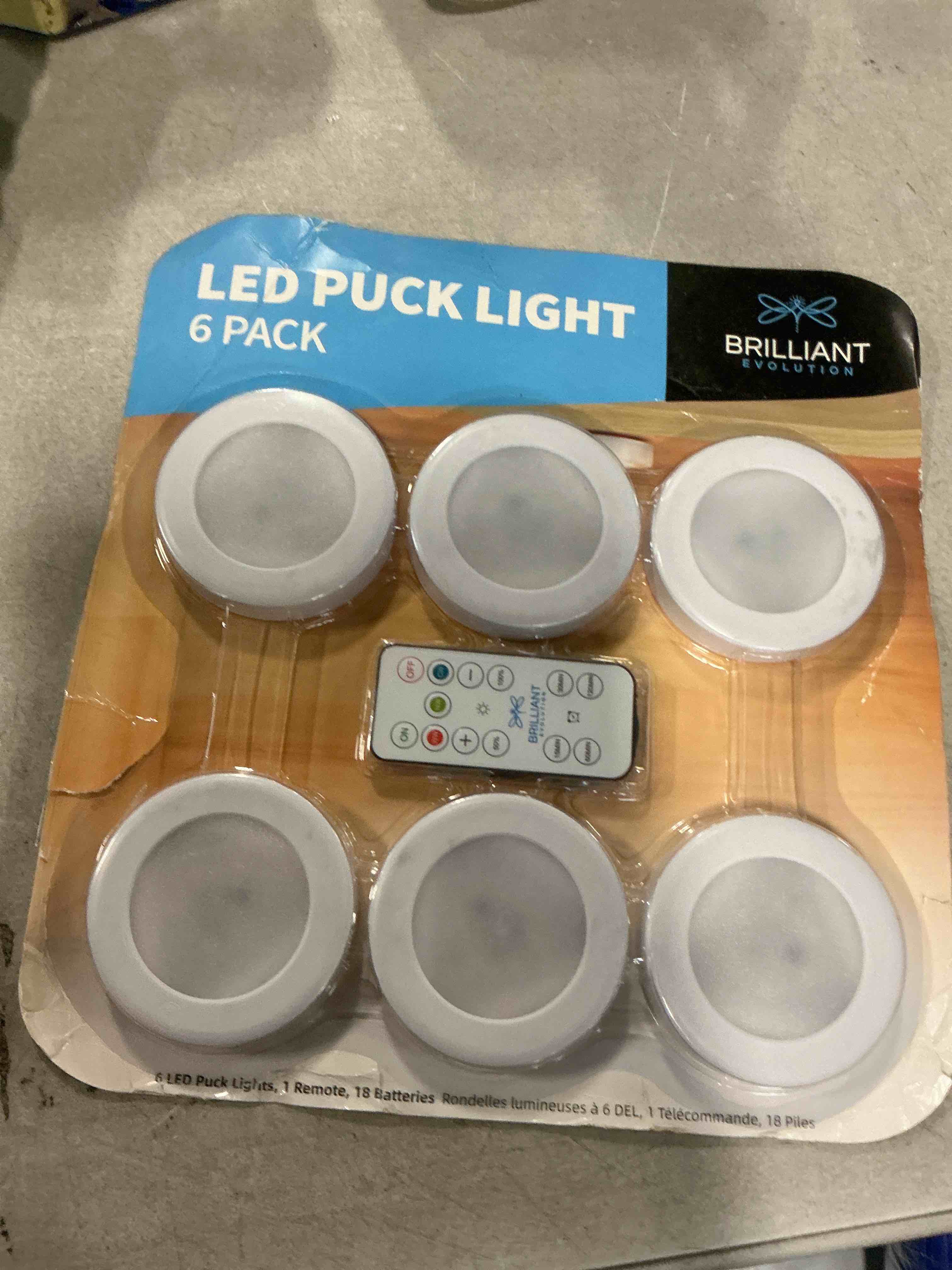 Condition photo showing item condition for Brilliant Evolution Tap Light Push Lights 6pk w/Batteries + Remote, LED Stick On Lights Under Cabinets Battery Puck Lights with Remote - Under Counter Lighting Wireless Closet Kitchen Night Lights