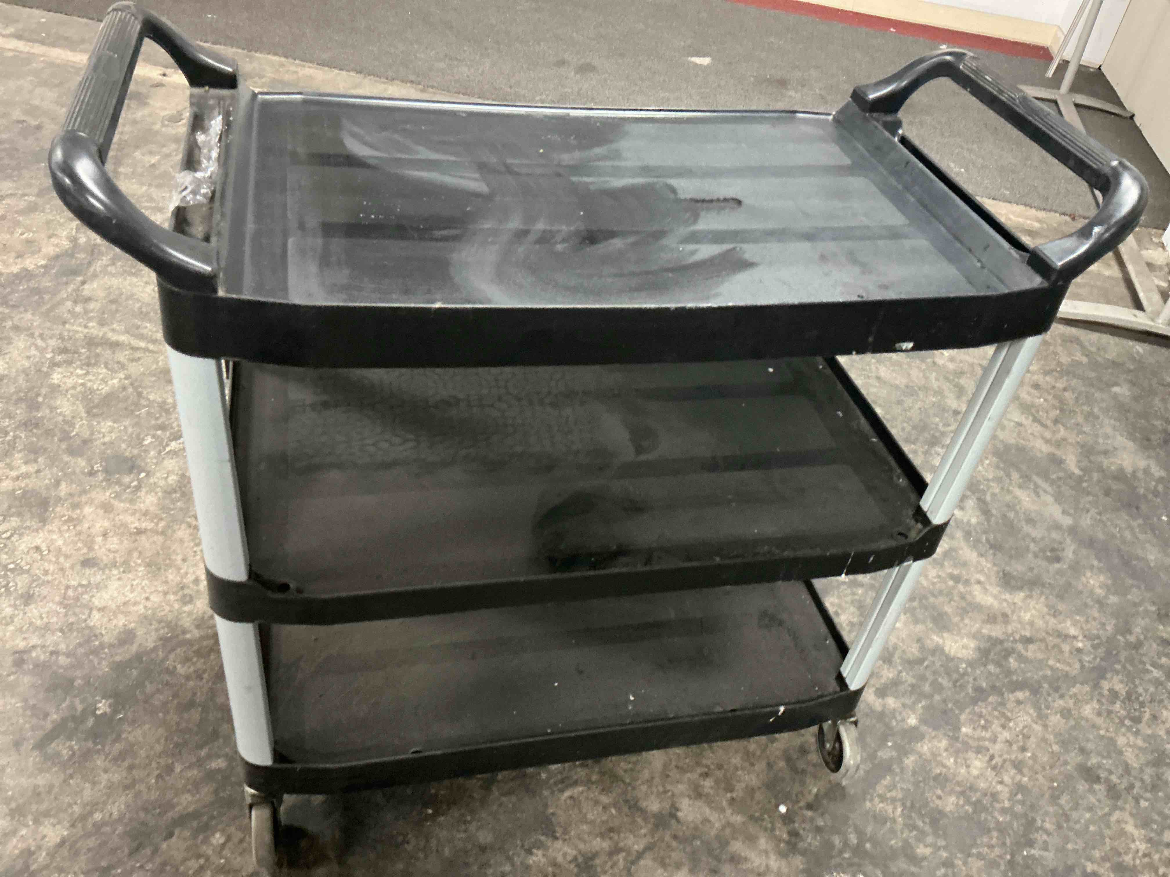 Condition photo showing As Is for Rubbermaid Commercial Products Heavy Duty 3-Shelf Rolling Service/Utility/Push Cart, 300 lbs. Capacity, Black, for Restaurant/Cleaning/Office use (FG409100BLA)