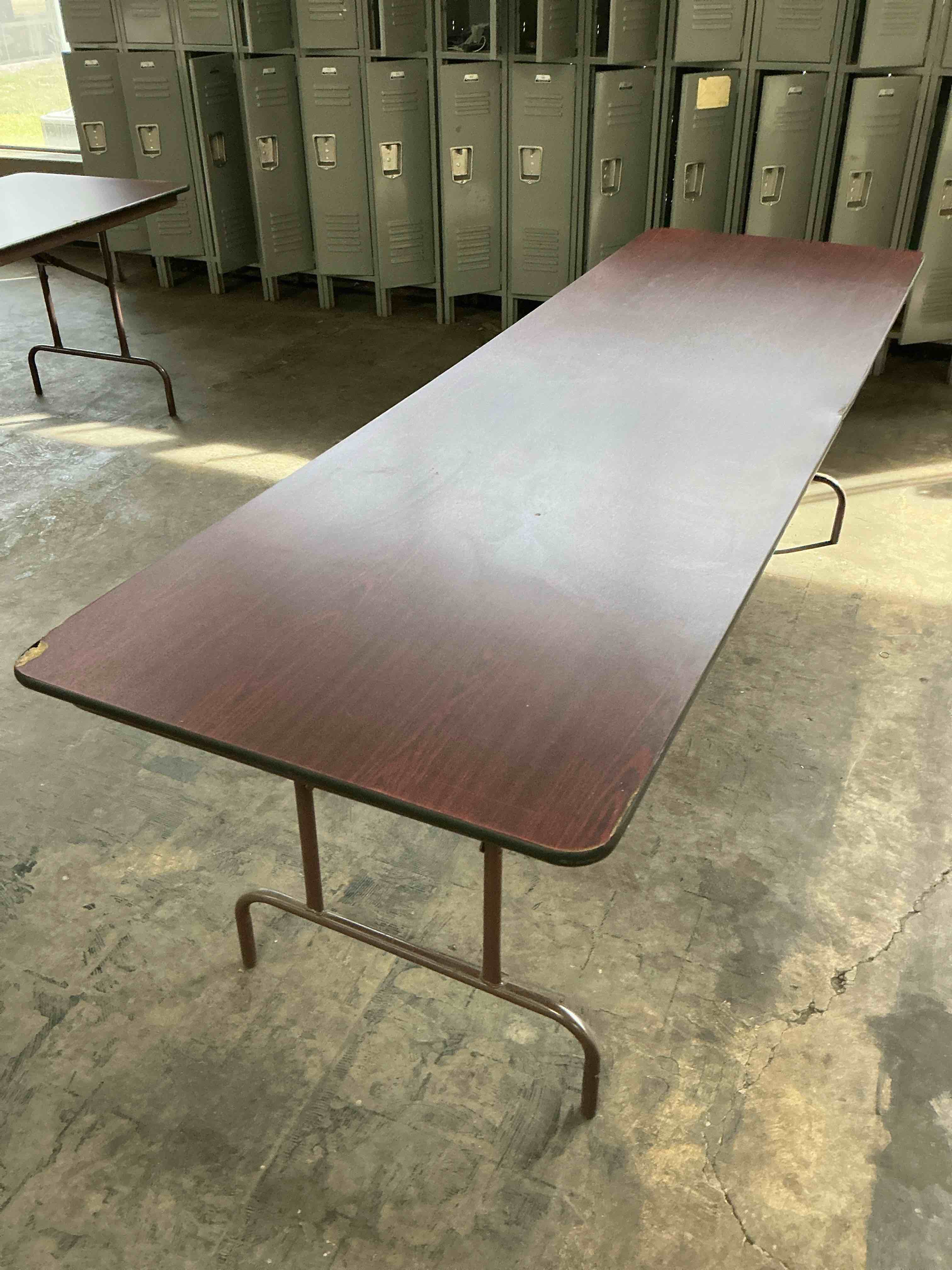 Condition photo showing As Is for EMMA + OLIVER 6-Foot Mahogany Melamine Laminate Folding Banquet & Catering Table