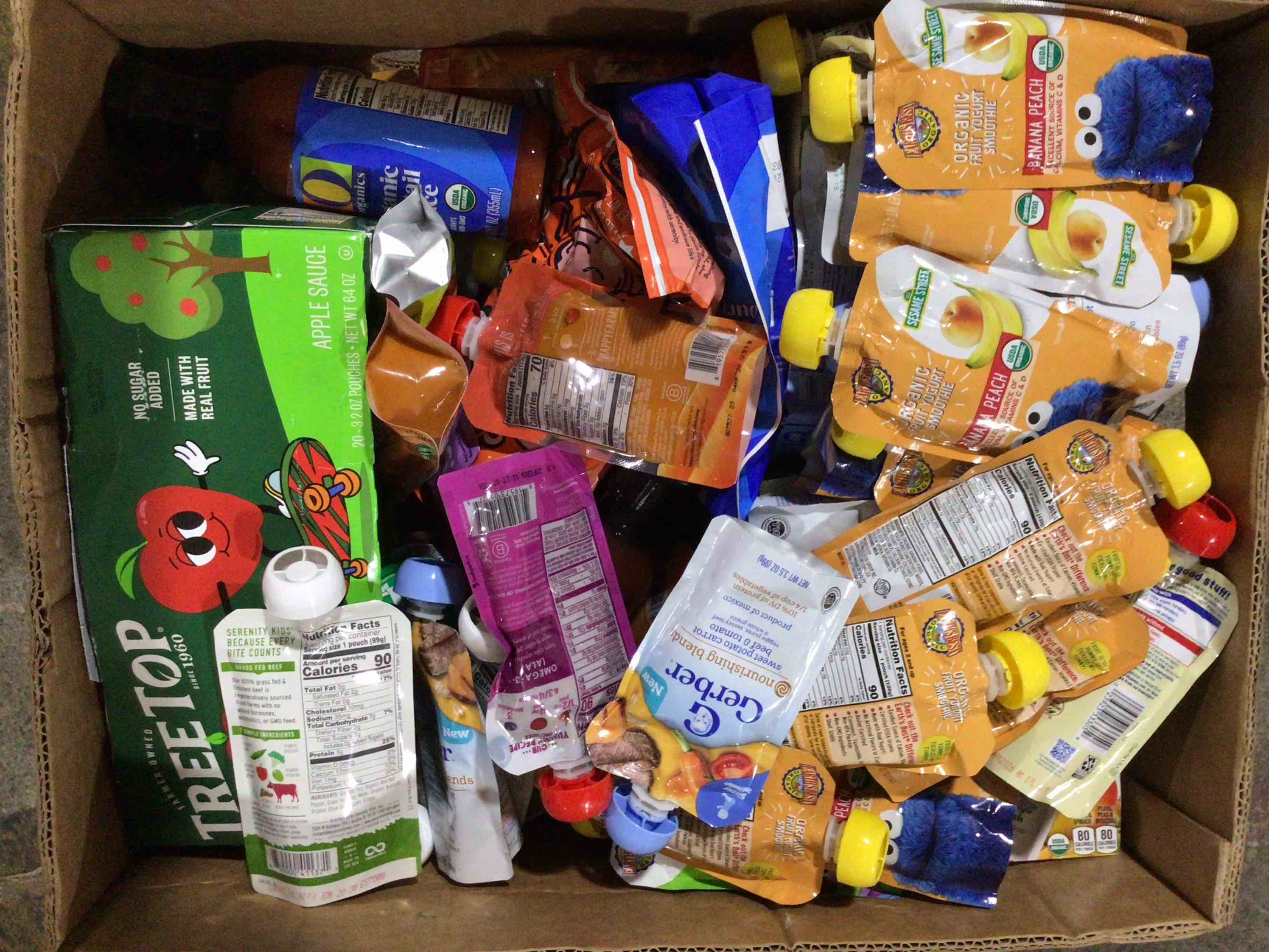 box of assorted grocery products / baby food / snacks