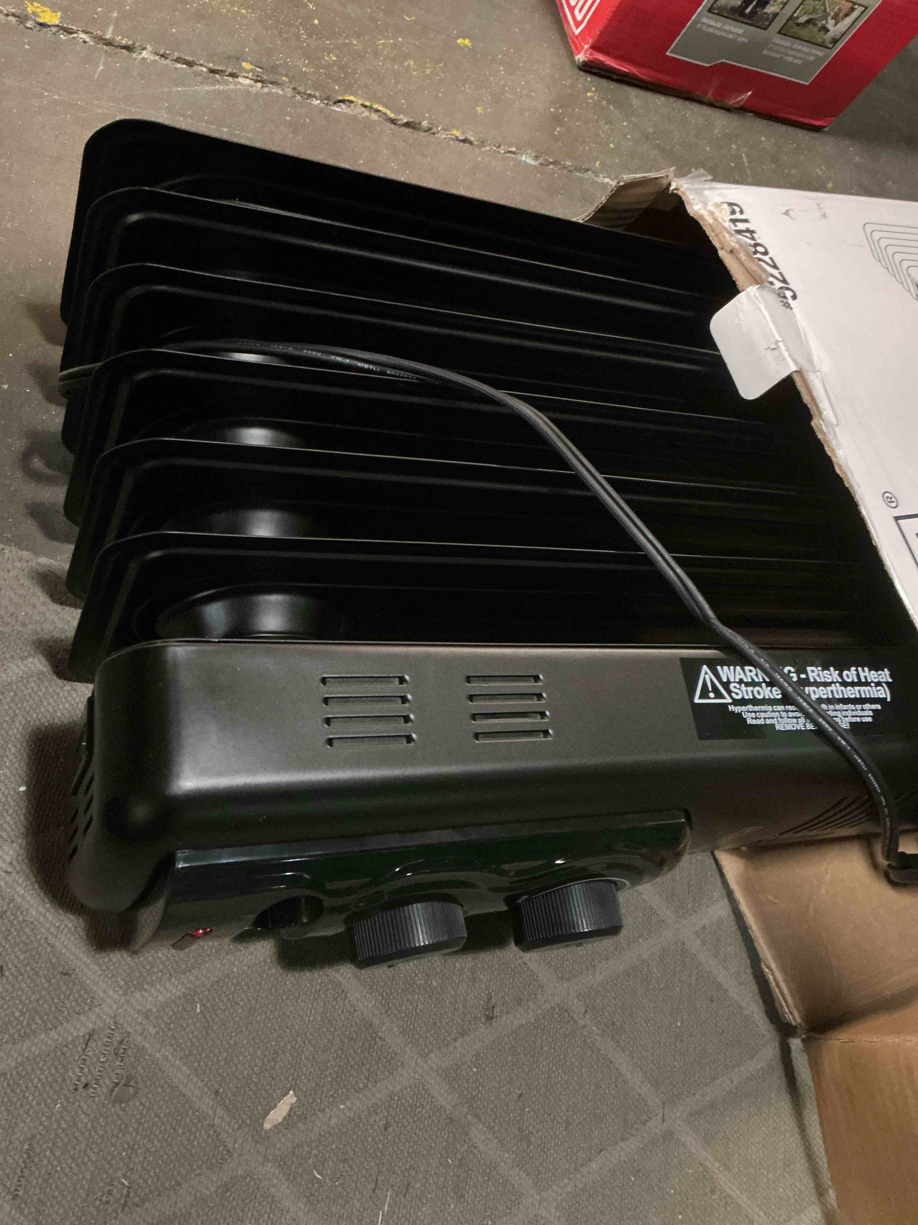Condition photo showing As Is for  utilitech 1500 -watt oil-filled radiant utility indoor electric space heater with thermostat