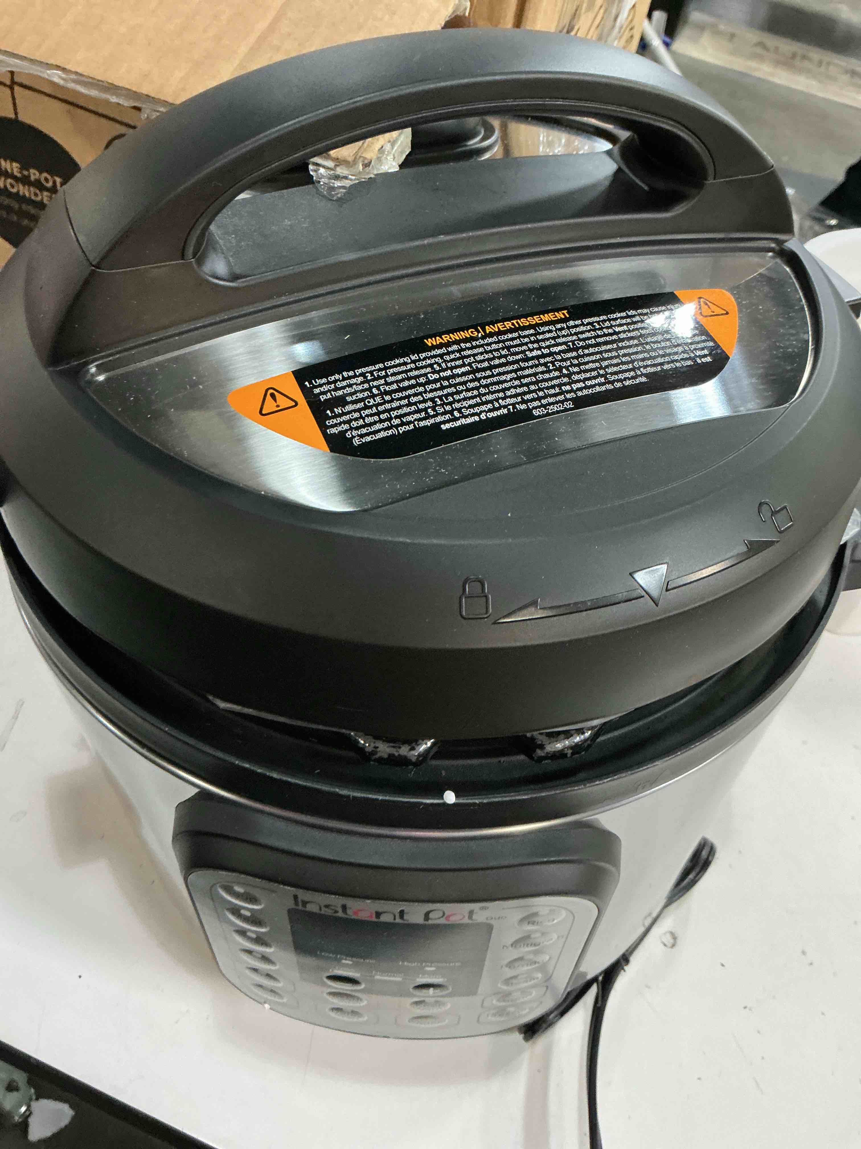 Condition photo showing As Is for instant pot duo 7-in-1 electric pressure cooker, slow cooker, rice, steamer, sauté, yogurt maker, warmer & sterilizer, includes app with over 800 recipes, stainless steel, 6 quart 6 quarts