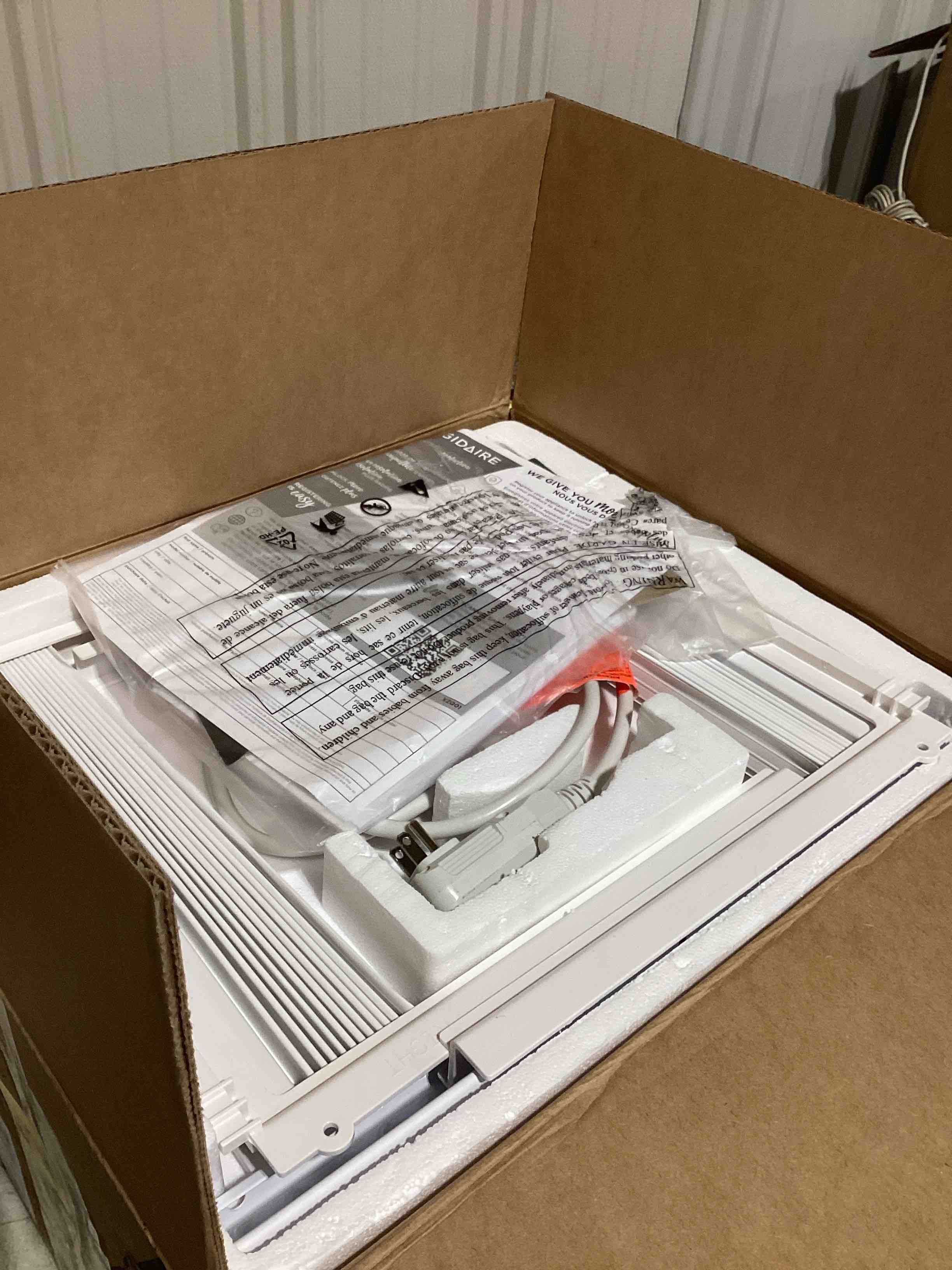 Condition photo showing As Is for frigidaire 5,000 btu window-mounted air conditioner, cools up to 150 sq. ft., quiet operation, effortless temperature control, 2 fan speeds, auto restart, white 5,000 btu mechanical controls