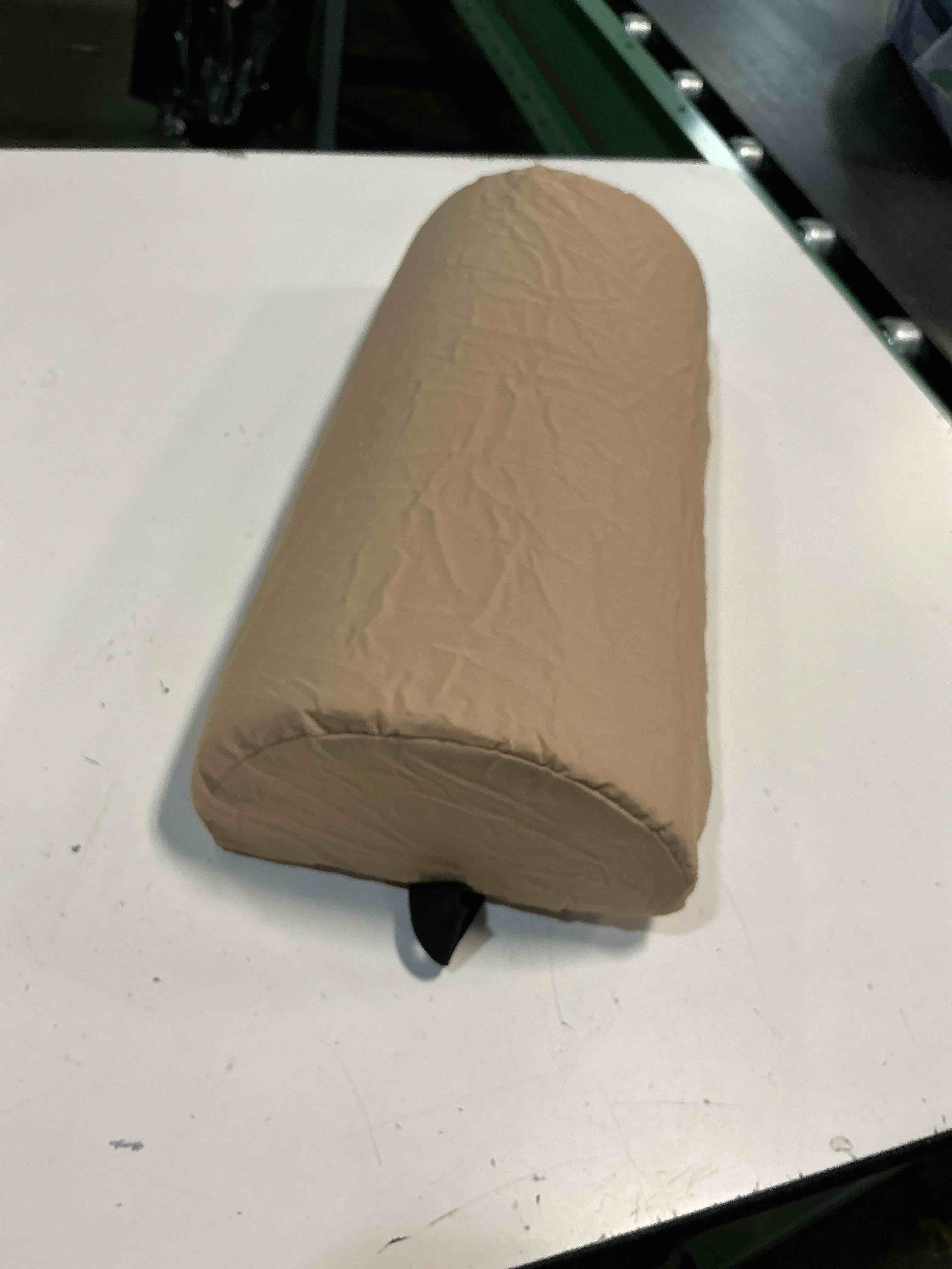 Condition photo showing As Is for tan lumbar pillow with strap