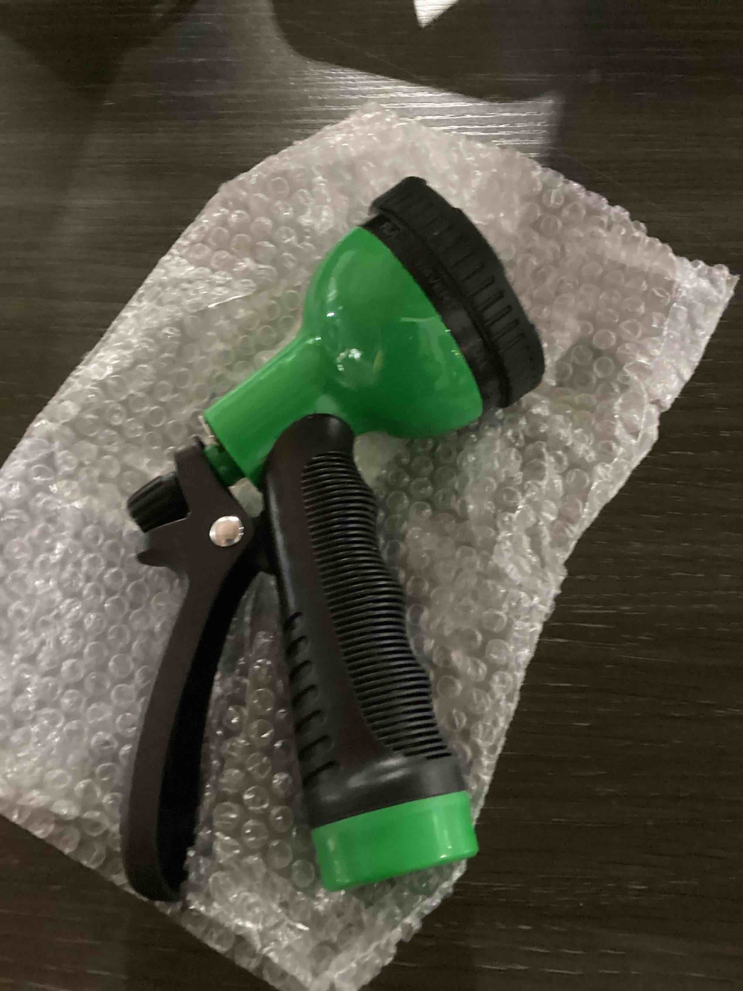 Condition photo showing New/Like New for green and black waterhose nozzle
