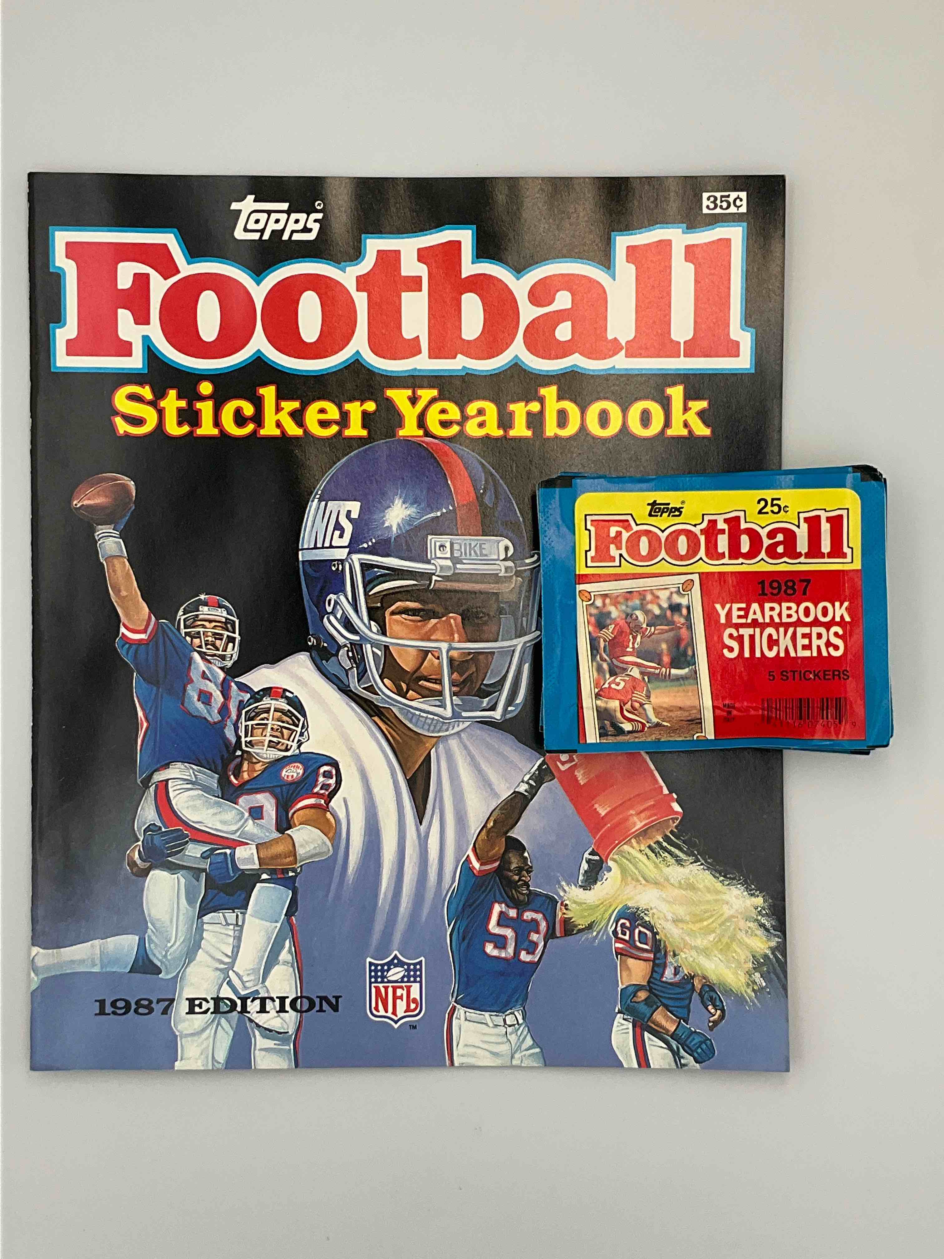 1987 Topps Football Sticker Yearbook Special! You'll See A Blue Moon Before You Ever See This Again! One Unused Topps 1987 Football Sticker Yearbook, & 20 Unopened Packs Of Matching 1987 Stickers To Use With Book (5 Stickers Per Pack, 100 Total Stickers). 21 Total Pieces In Lot. Both Sticker Yearbook & Sticker Packs Are Direct From Original Retail Dealer Box. Stickers Could Also Be Used To "Stick Anywhere." Here's Your Chance To Own Some Very Unique Football History & Incredible Sports Memorabilia... 1987 Is A Rare Football Year With Tons of Star Rookies Such As Reggie White, Herschel Walker & Jim Kelly. Super Rare!