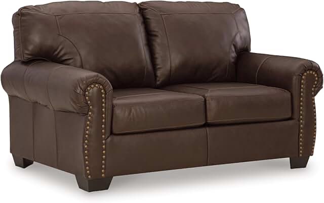 Signature design by Ashley Oberg Foss, leather loveseat with male head, trim, two accent pillows gray