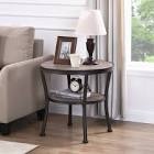 Aderes End Table with storage Anchor your living room seating ensemble in industrial flair with this understated end table. Constructed of durable MDF board with rustic brown veneer, this charming piece is easy to maintain. One clean-lined lower shelf is great for displaying books and magazines, while the spacious tabletop is the ideal height to set a glass, a lamp, some framed photos, or other items you'd like nearby. Blending rustic style with an approachable contemporary design, this charming end table is a perfect addition to any seating group. In addition, the thick top shelf and heavy-duty metal frame ensure that the end table will hold up well for years.