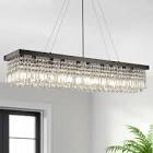 Anacelia 31.5 b39/47 Black/Gold Chandeliers 6/8/10 light mode Add elegance and glamour to your space with our stunning rectangular crystal chandelier. Featuring K9 crystals and a sturdy stainless steel frame, each crystal is finely cut to create a mesmerizing glow when illuminated. The chandelier's design includes three different crystal shapes, adding visual layers and enhancing its decorative appeal. Ideal for hanging above a kitchen island, it not only brightens the space but also makes cooking and cleaning easier. Available in Black and Gold, and in sizes of 31.5", 39", and 47", theres a perfect fit for every home.