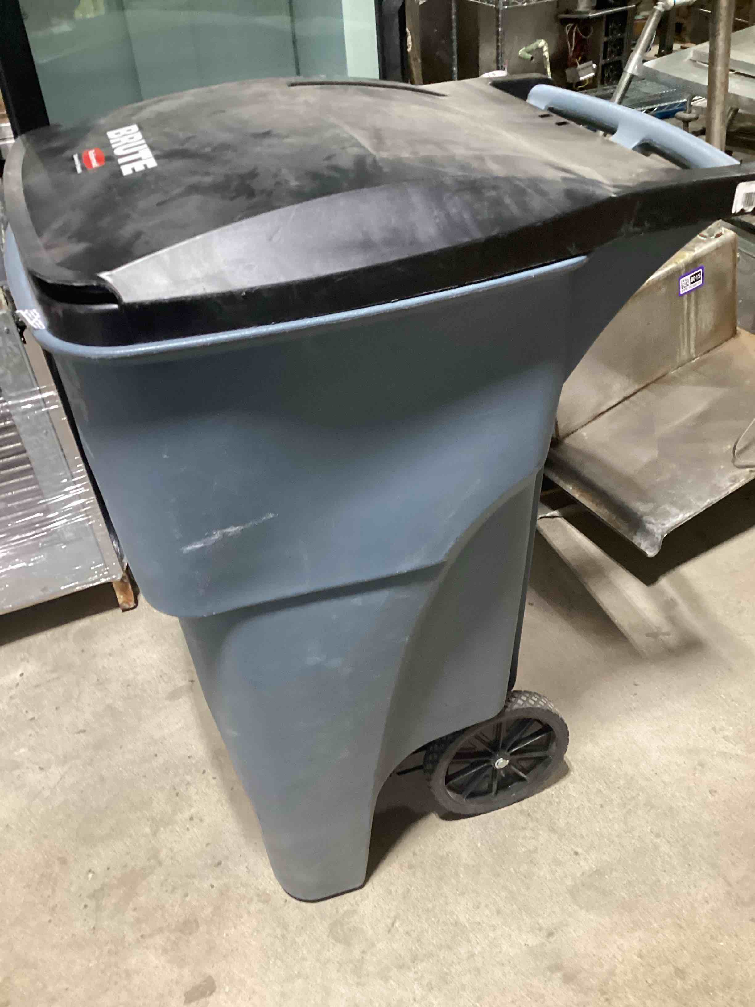 Condition photo showing As Is for Rubbermaid Commercial Products Brute Rollout Trash/Garbage Can/Bin with Wheels, 32 GAL, for Restaurants/Hospitals/Offices/Back of House/Warehouses/Home, Gray (1971941)
