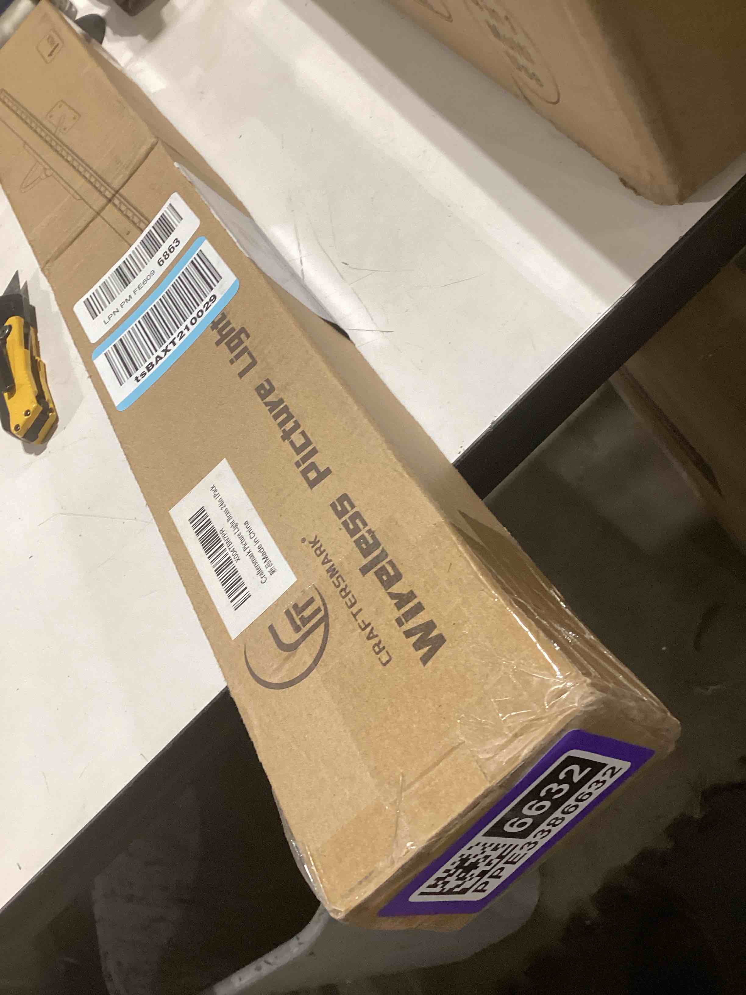 Condition photo showing As Is for 24 Inch Picture Light for Wall - Brass Battery Operated Wireless Wall Sconce with Remote & Timer for Artwork, Portrait, Photo & Frame Brass 1Pack - 24 in