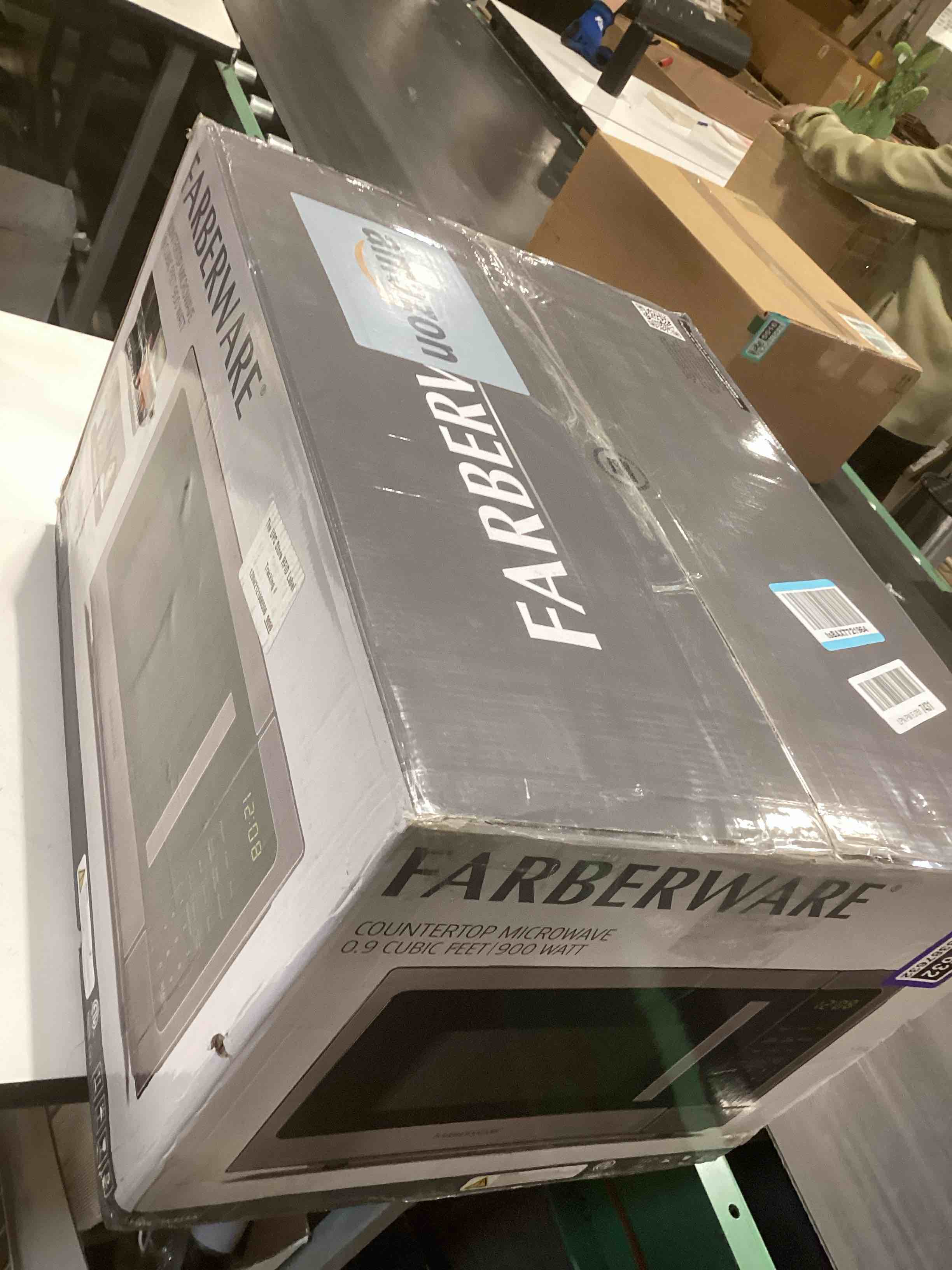 Condition photo showing As Is for Farberware 0.9 Cu. Ft. Countertop Microwave Oven – 900 Watts Power, Auto Cook Settings, Defrost, Easy Clean and Child Safety Lock - Stainless Steel 0.9 Cu. Ft. Stainless Steel