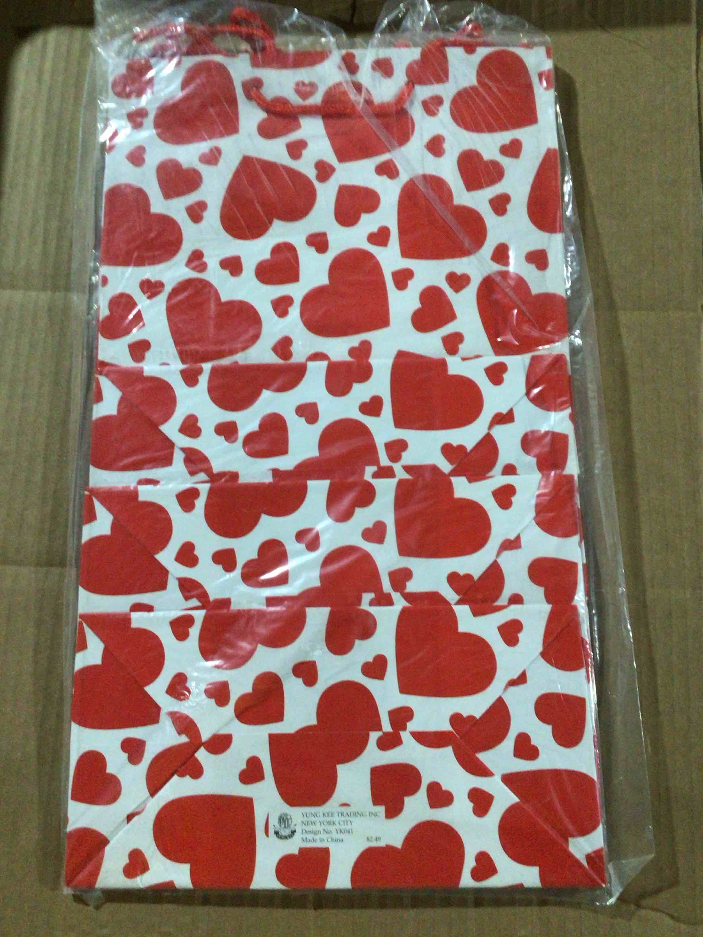 Paper gift with a red hear print 