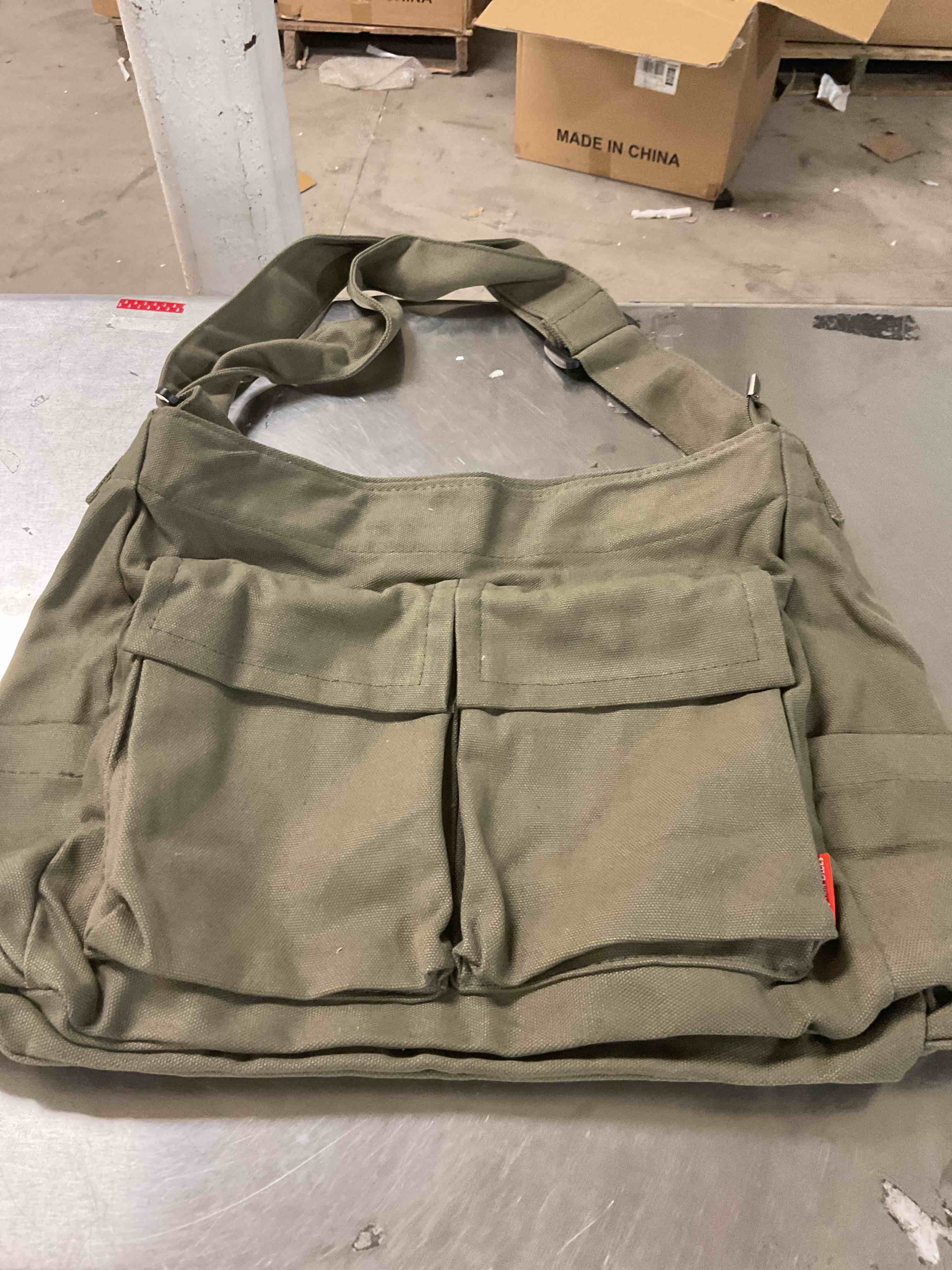 Green tote bag with multiple pins designs