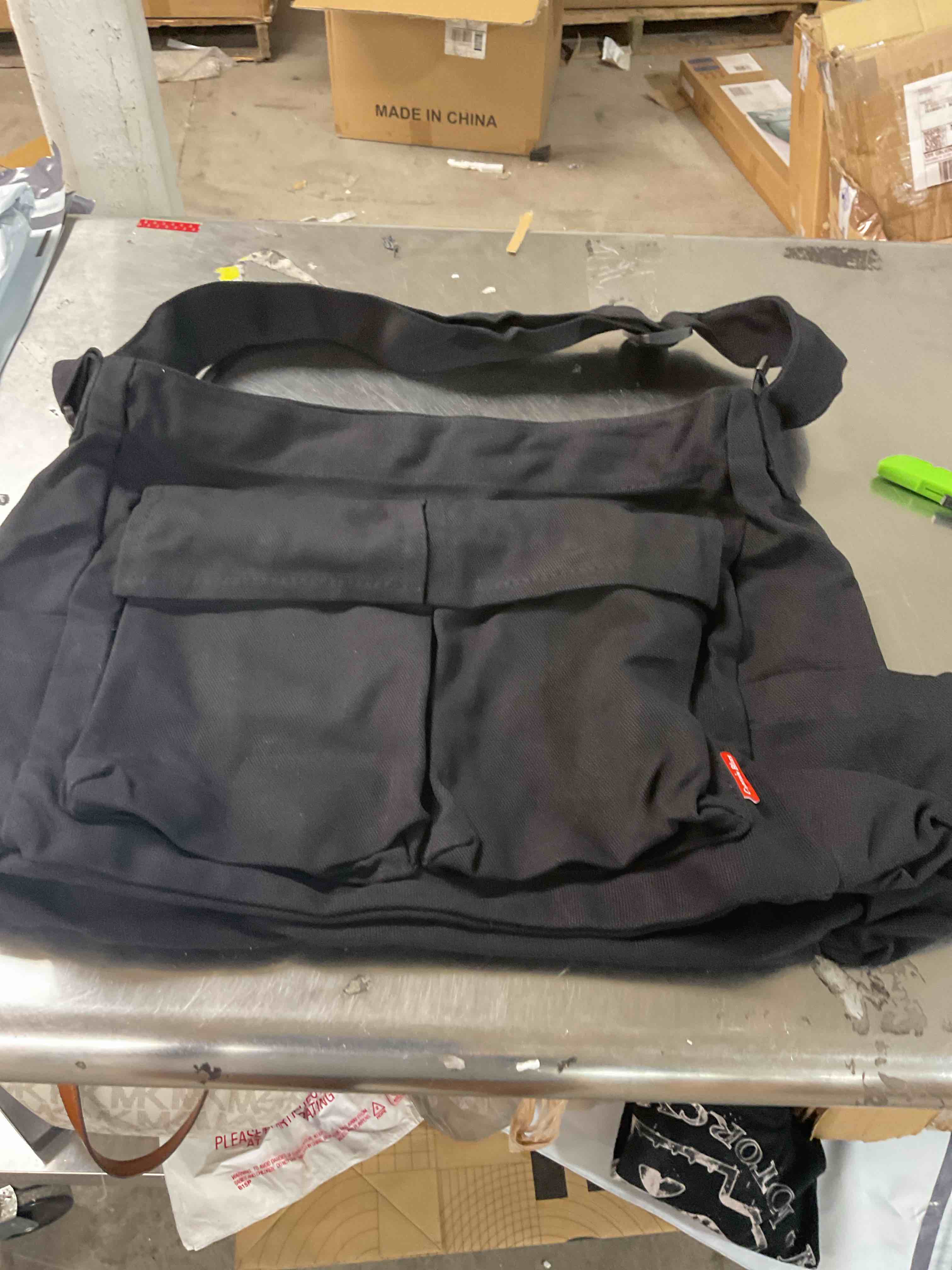 Black tote bag with assorted pins 