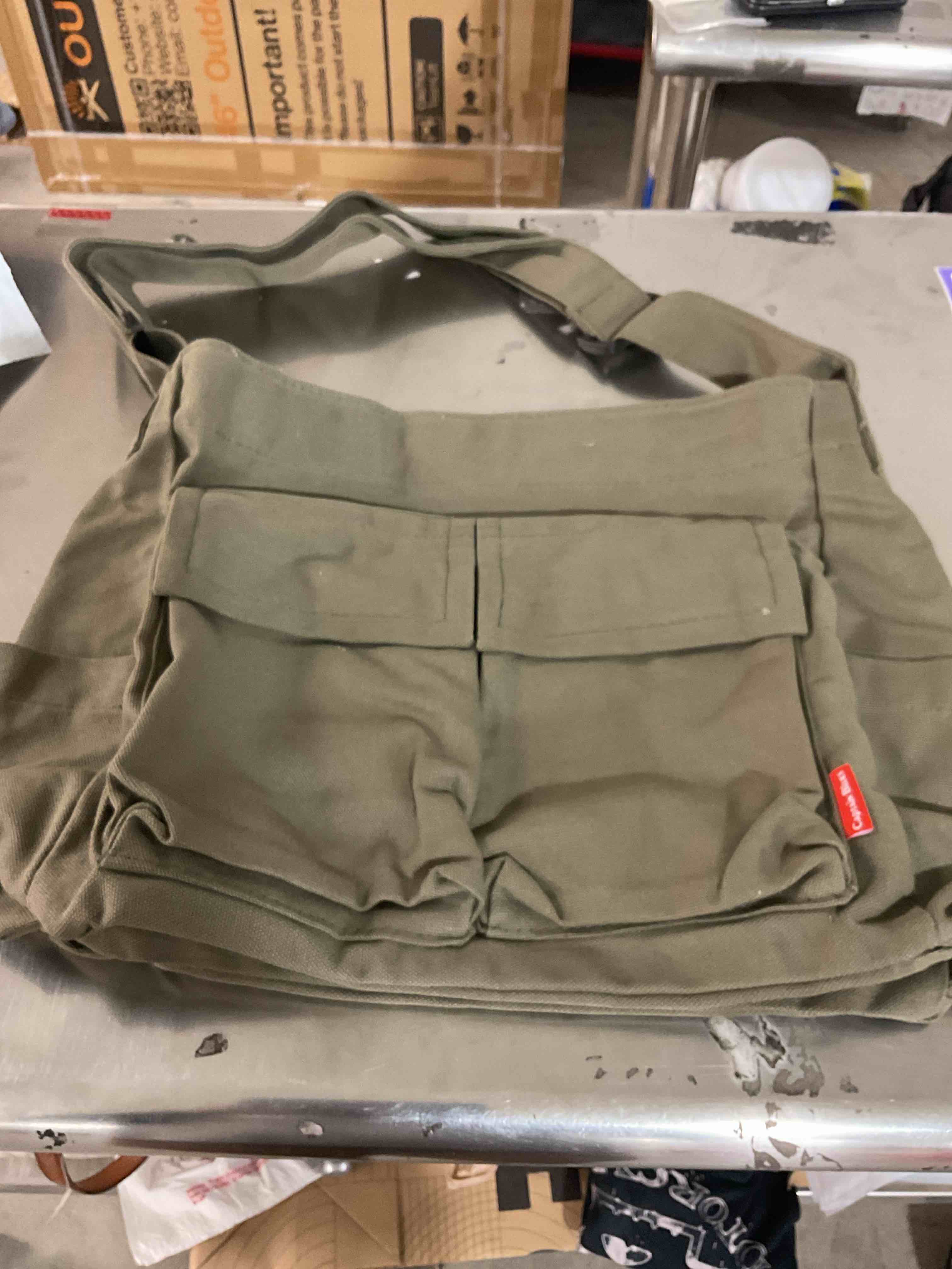 Green tote bag with assorted pins