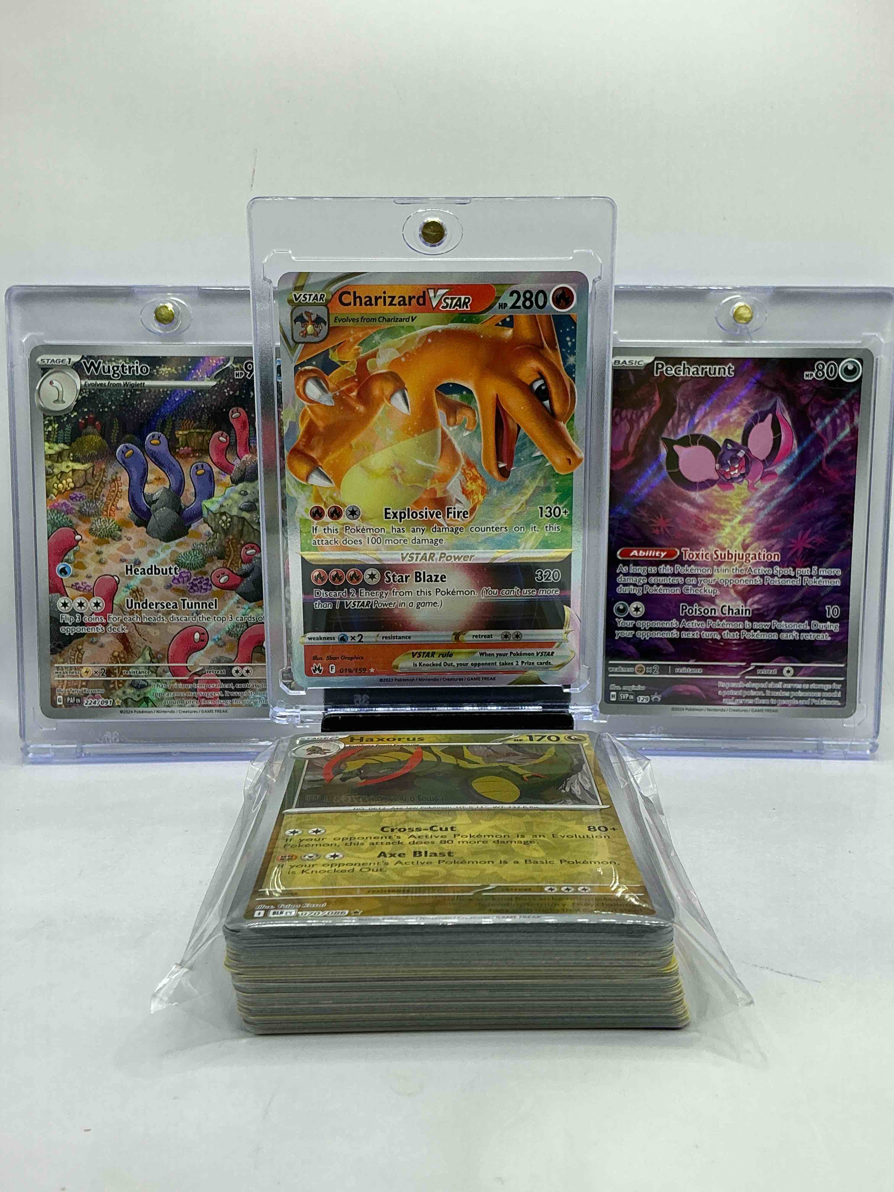 Charizard VStar! Along With 2 Full Art Pokémon! Charizard, Wugtrio & Pecharunt! Along With 50 Other Pokémon Heroes, Holos, Legends & Commons- Including 1 Stage Two Rare Holographic, 2 Stage One Rare Holographic, 3 Basic Rare Holographic, 4 Common/ Uncommon Holographics (All Stages), 2 Stage Two Non Holographic & 2 Rares! Also Includes 36 Non Holo Common/ Uncommon Basic & First Stage Cards Trainers & Energy Too! Perfect Set For Collectors & Enthusiasts!