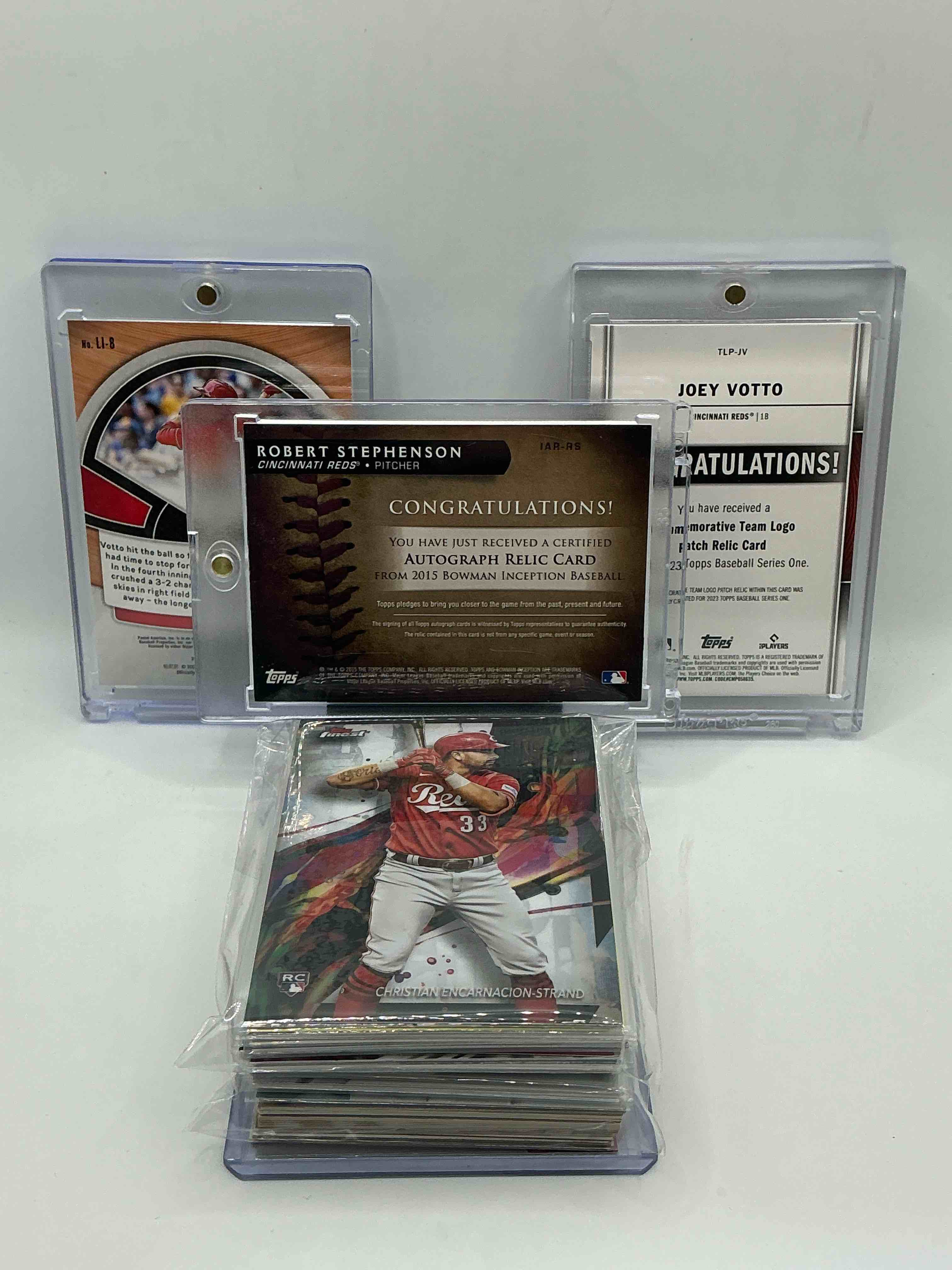 Condition photo showing New/Like New for reds rambunctiousness! 2015 topps bowman inception rookie patch autograph robert stephenson numbered 24/50! 2023 topps commemorative team reds logo patch relic joey votto! 2022 silver prizm lumber inc joey votto! along with 50 other reds heroes, legends, rookies & commons!