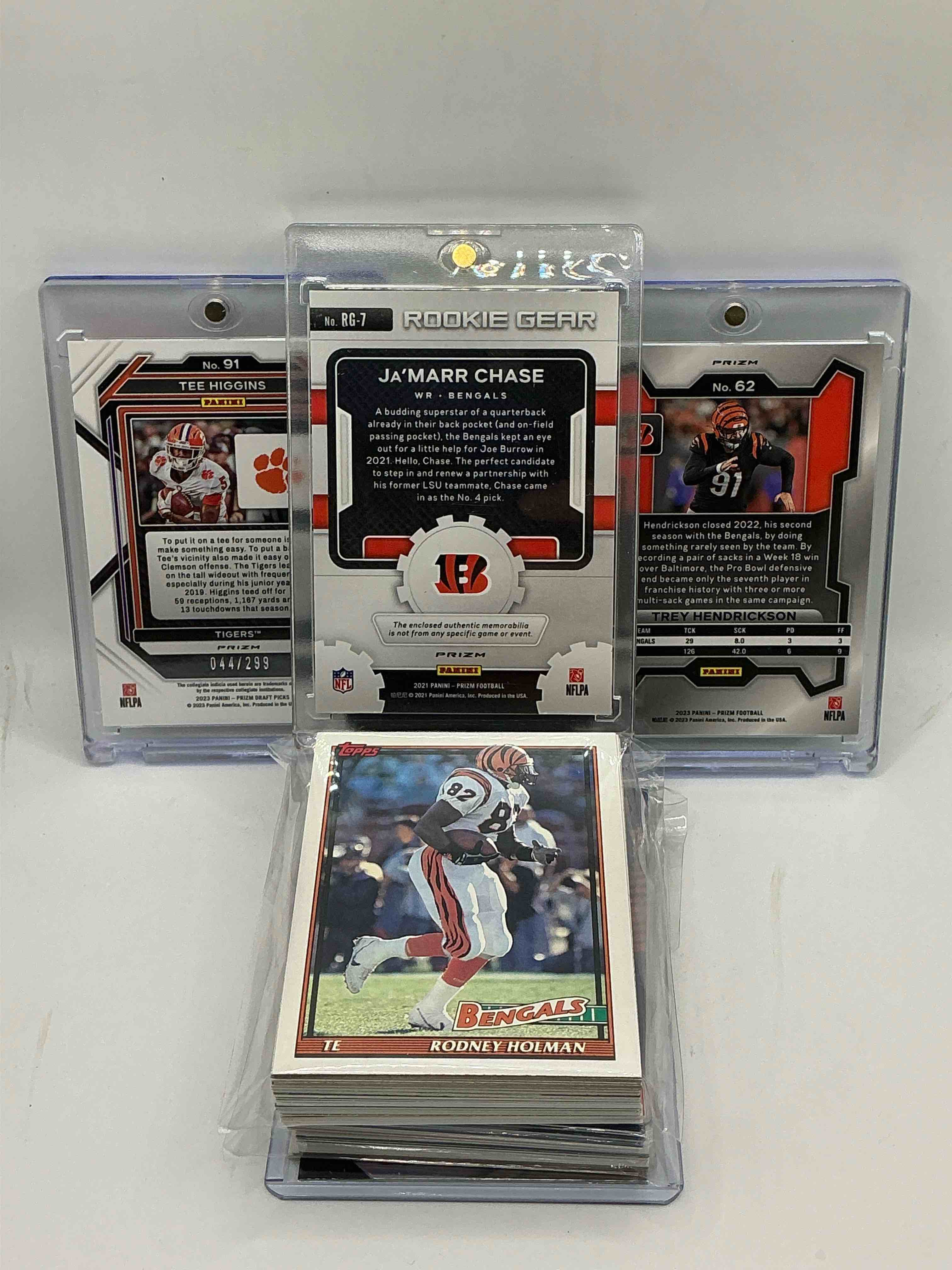 Condition photo showing New/Like New for bengals bonanza! 2021green prizm rookie gear patch ja’marr chase! 2023 rare green prizm trey hendrickson! 2023 red prizm draft picks tee higgins numbered 44/299! along with 50 other bengals heroes, legends, rookies & commons!