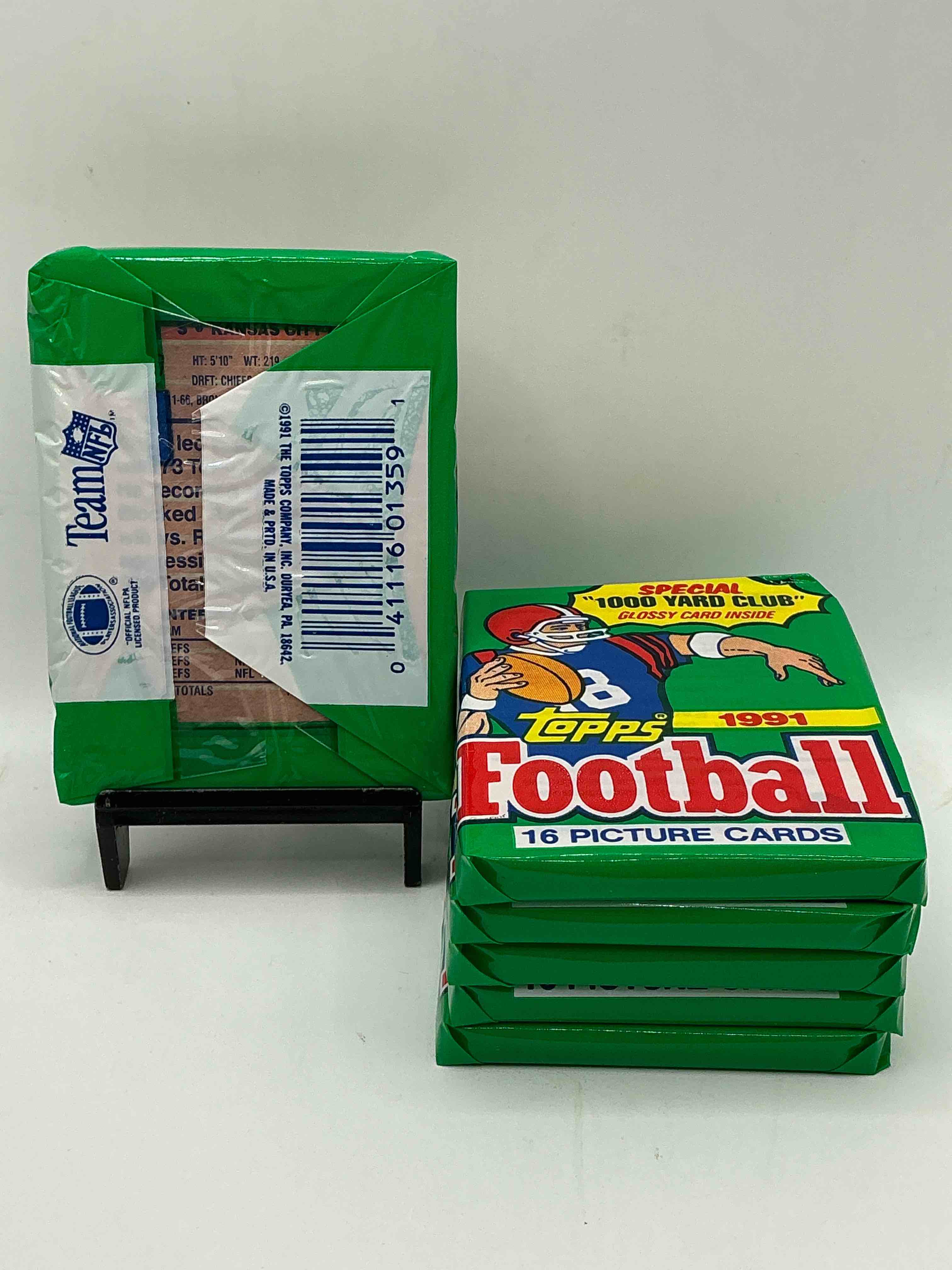 Condition photo showing New/Like New for 1991 topps football unopened sports card wax pack, direct from original retail case. search for early barry sanders, emmitt smith, jerry rice & joe montana!
