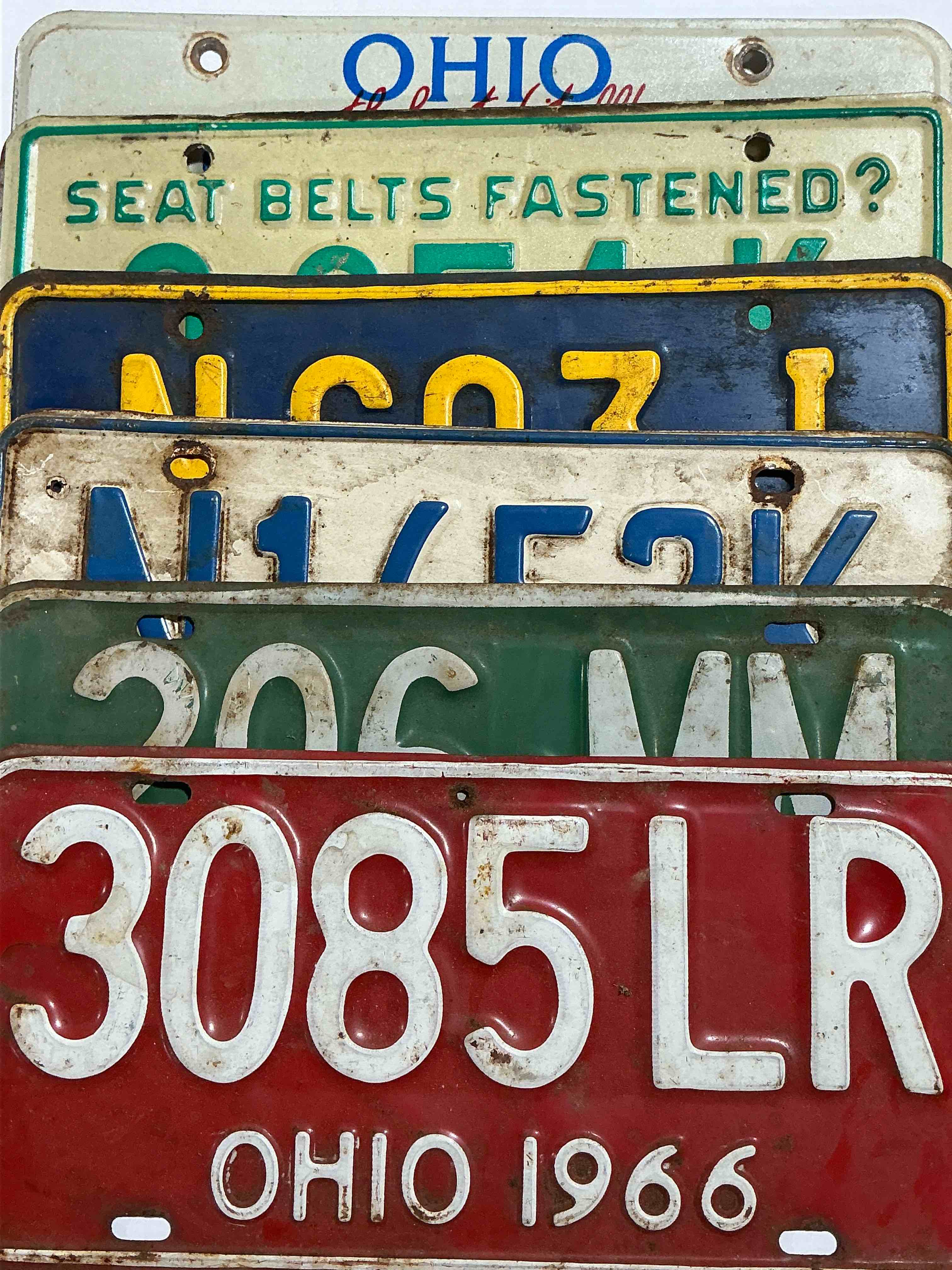 license plate history, wow!  authentic, original ohio license plates spanning multiple decades!  these are genuine heavy metal time pieces, not replicas!  some rust & barn dust included!  almost impossible to find!  