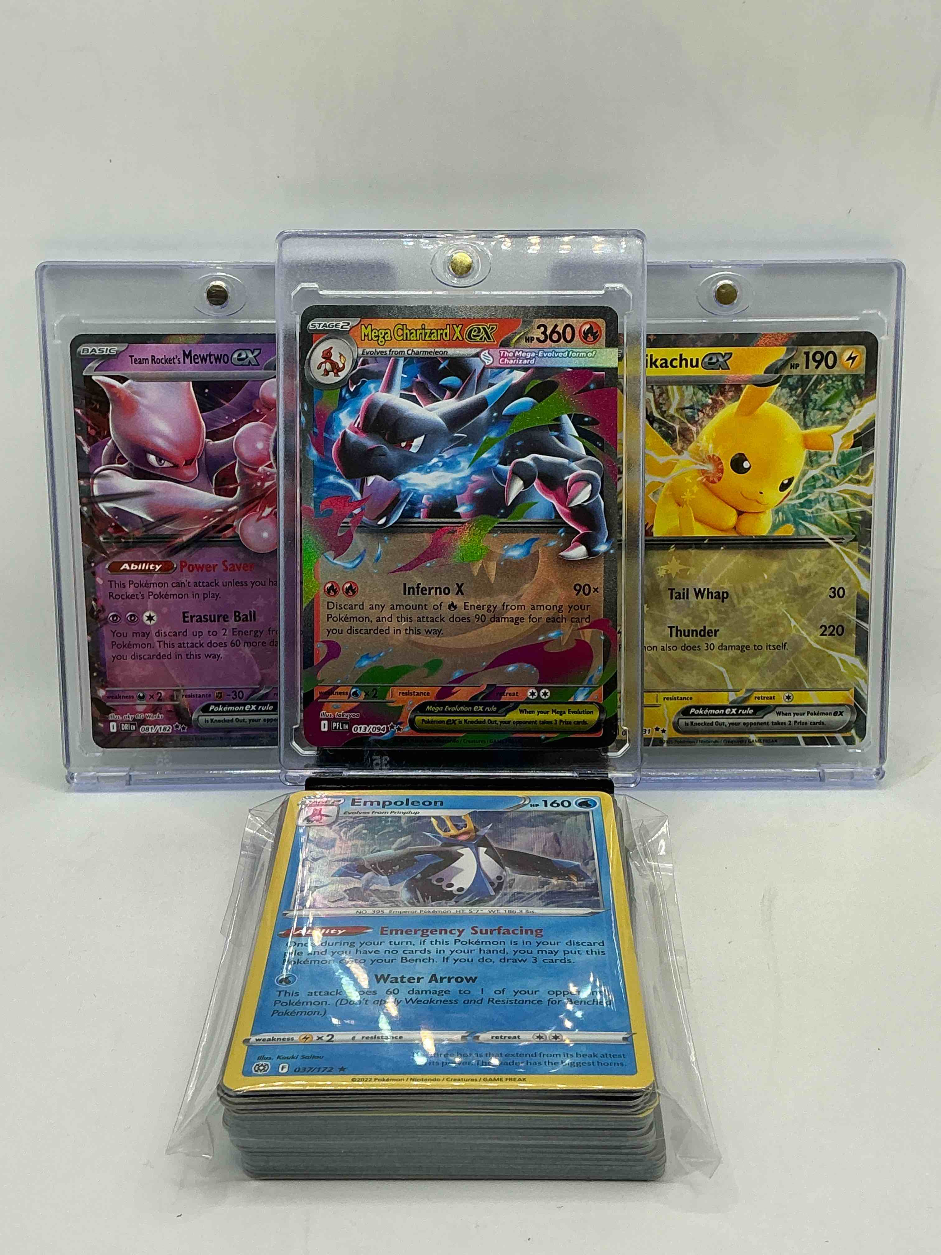 Pokémon Party! Mega Charizard X EX! Team Rocket’s Mewtwo EX! Pikachu EX! Along With 50 Other Pokémon Heroes, Holos, Legends & Commons- Including 1 Stage Two Rare Holographic, 2 Stage One Rare Holographic, 3 Basic Rare Holographic, 4 Common/ Uncommon Holographics (All Stages), 2 Stage Two Non Holographic & 2 Rares! Also Includes 36 Non Holo Common/ Uncommon Basic & First Stage Cards Trainers & Energy Too! Perfect Set For Collectors & Enthusiasts!