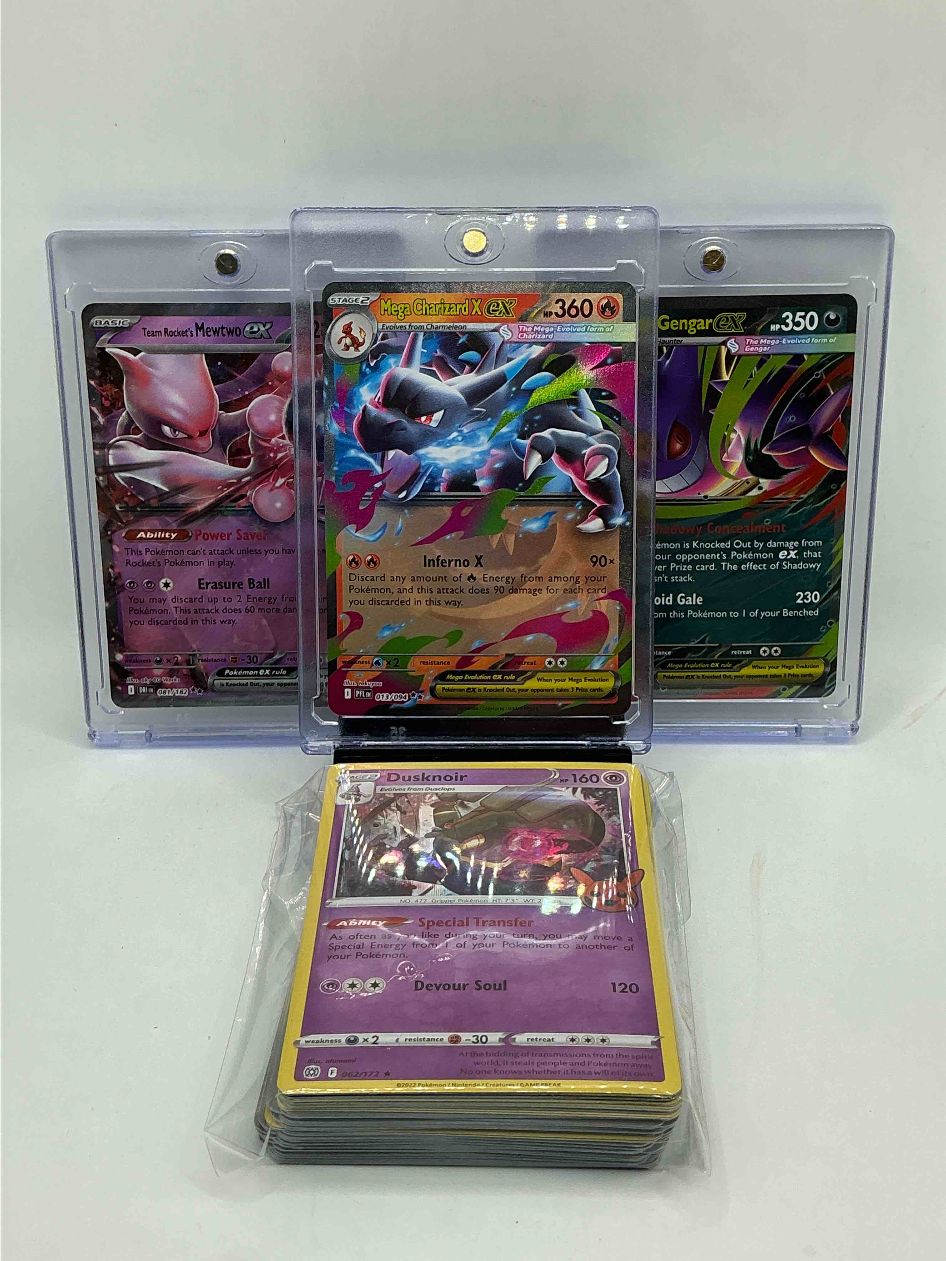 Pokémon Party! Mega Charizard EX! Mega Gengar EX! Team Rocket’s Mewtwo EX! Along With 50 Other Pokémon Heroes, Holos, Legends & Commons- Including 1 Stage Two Rare Holographic, 2 Stage One Rare Holographic, 3 Basic Rare Holographic, 4 Common/ Uncommon Holographics (All Stages), 2 Stage Two Non Holographic & 2 Rares! Also Includes 36 Non Holo Common/ Uncommon Basic & First Stage Cards Trainers & Energy Too! Perfect Set For Collectors & Enthusiasts!