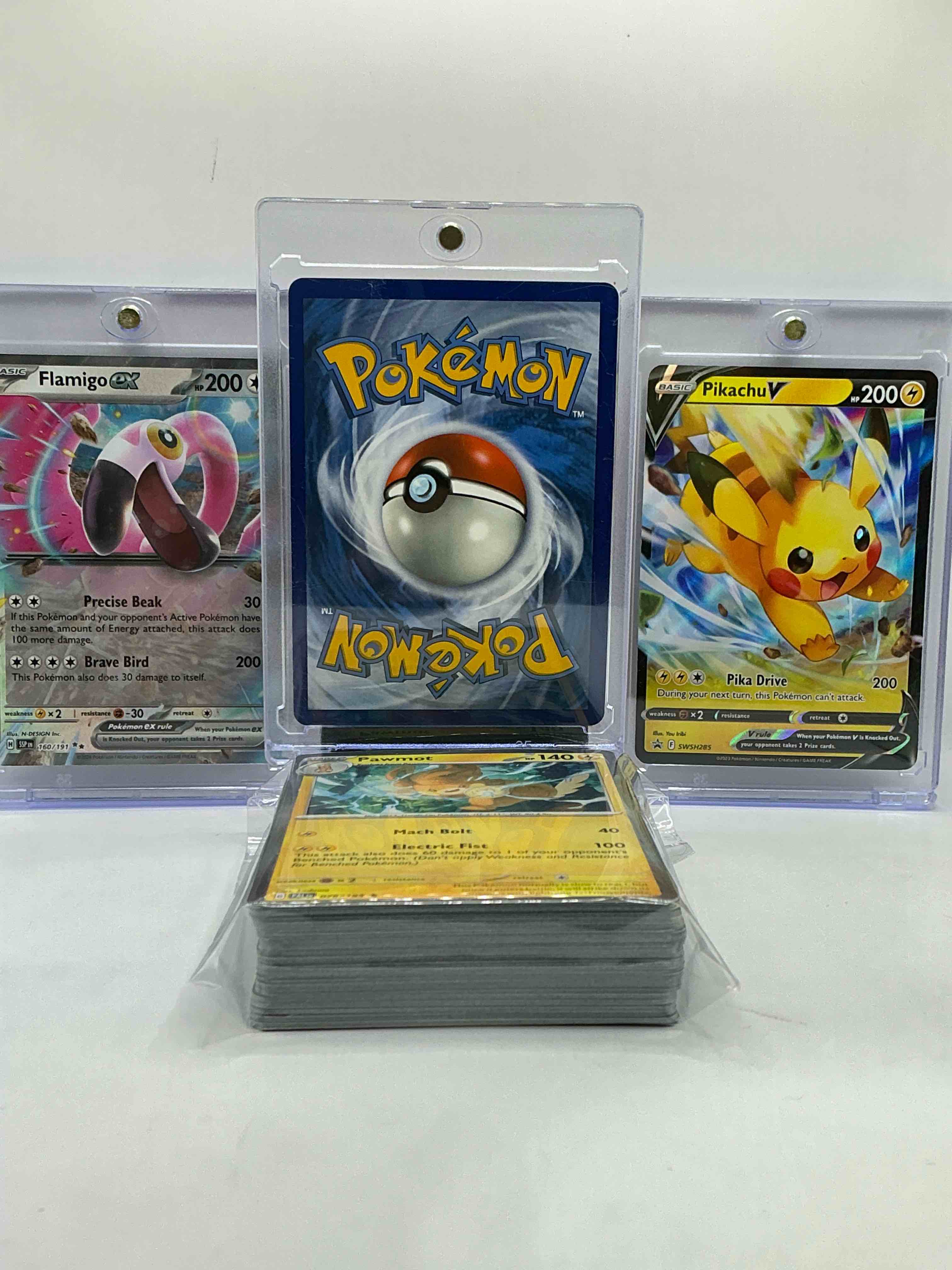 Condition photo showing New/Like New for charizard gx, pikachu v & flamingo ex wow! along with 50 other pokémon heroes, holos, legends & commons- including holographic cards, stage 2 cards, holos in all forms & more! also includes 36 non holo common/ uncommon basic & first stage cards trainers & energy too! perfect set for collectors & enthusiasts!
