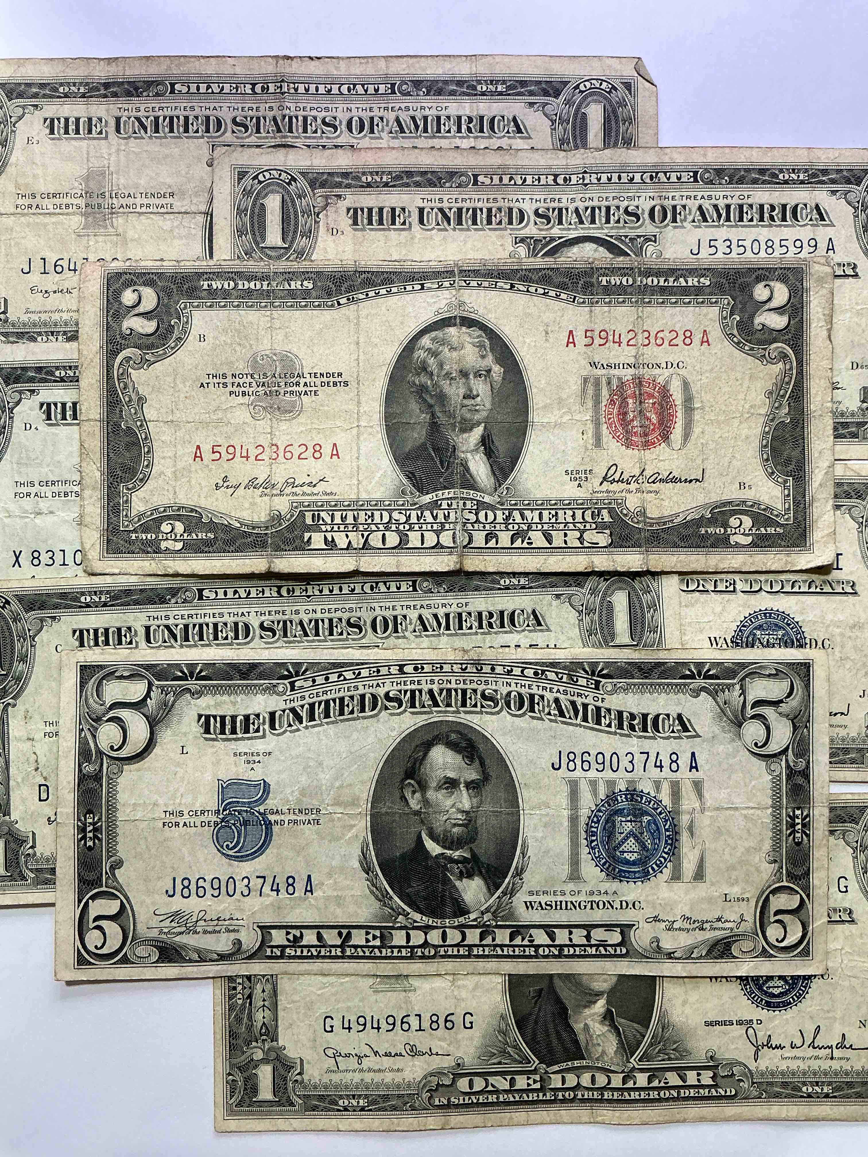 rare american dollar bills! blue seal five dollar bill & red seal two dollar bill, along with silver certificates! five dollar bill ultra rare & in good condition, red seal two dollar bill in good condition & silver certificates produced from 1878 to 1964 & are still considered legal tender at face value. here are gorgeous, circulated 1935 & 1957 u.s. one dollar silver certificate, with highly collectible "blue seal!* own an awesome piece of history! american dollar lot! 