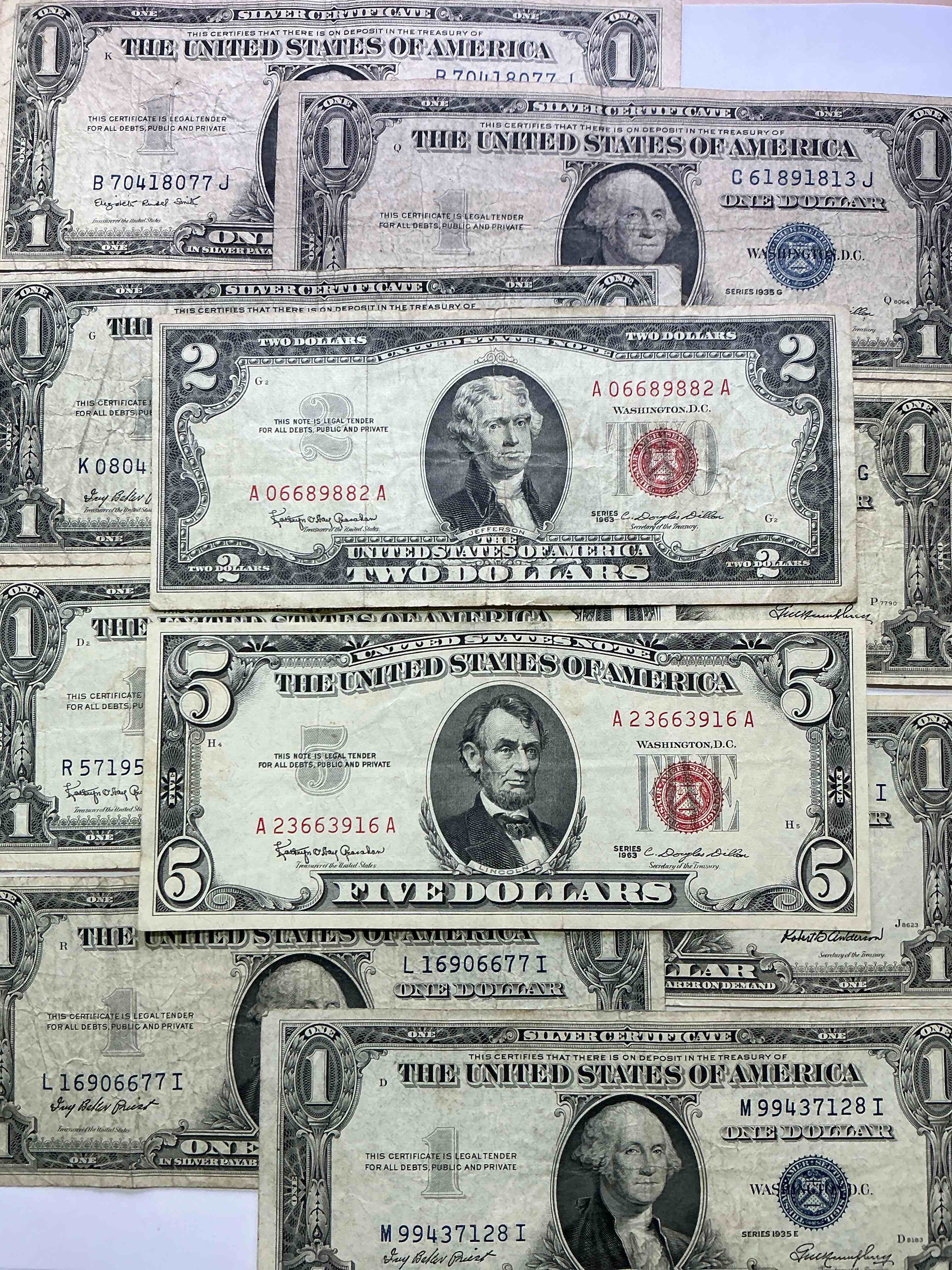 rare american dollar bills! red seal five dollar bill & red seal two dollar bill, along with silver certificates! five dollar bill ultra rare & in good condition, red seal two dollar bill in good condition & silver certificates produced from 1878 to 1964 & are still considered legal tender at face value. here are gorgeous, circulated 1935 & 1957 u.s. one dollar silver certificate, with highly collectible "blue seal!* own an awesome piece of history! american dollar lot! 